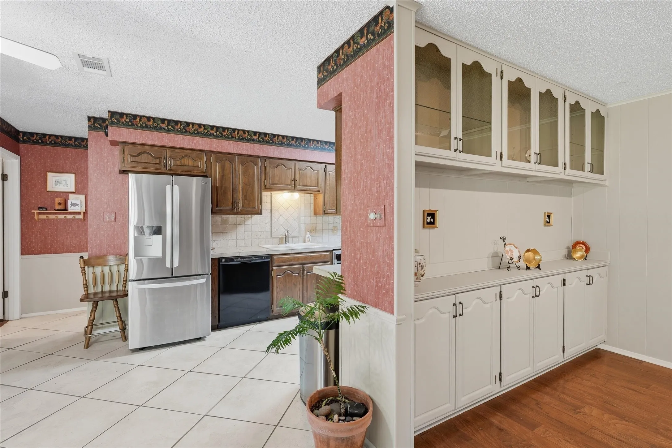 Built-in cabinetry with glass-front uppers and solid lower storage