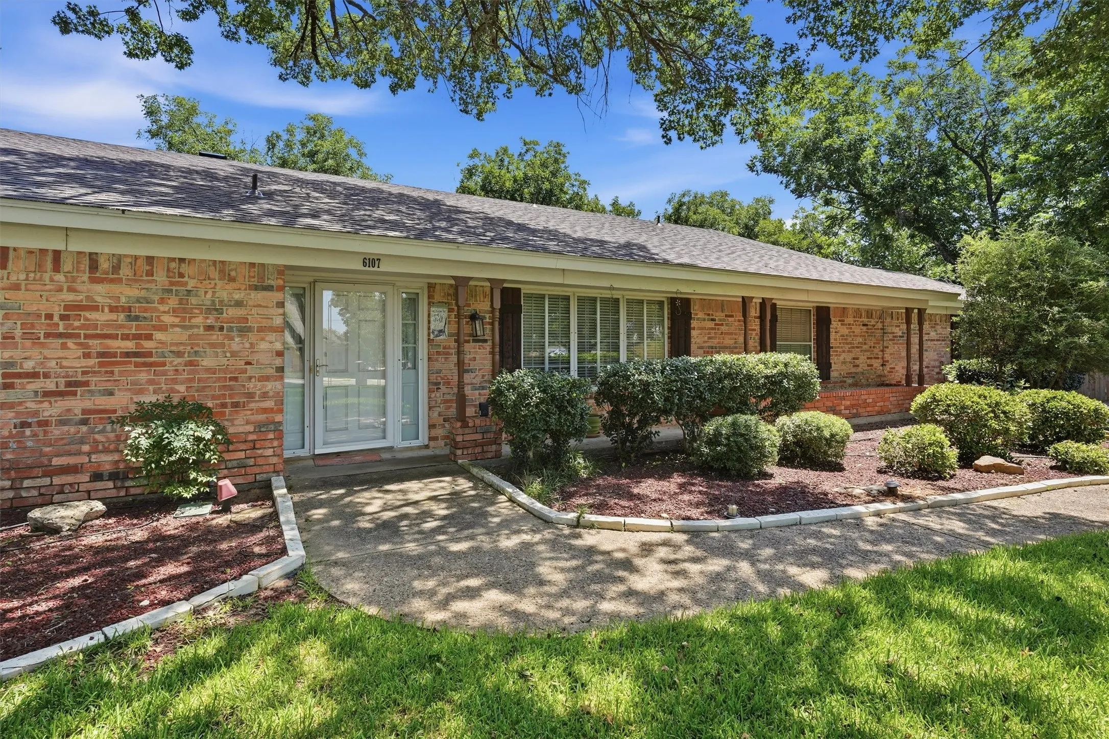 Brick exterior with a gabled roof and a covered entry