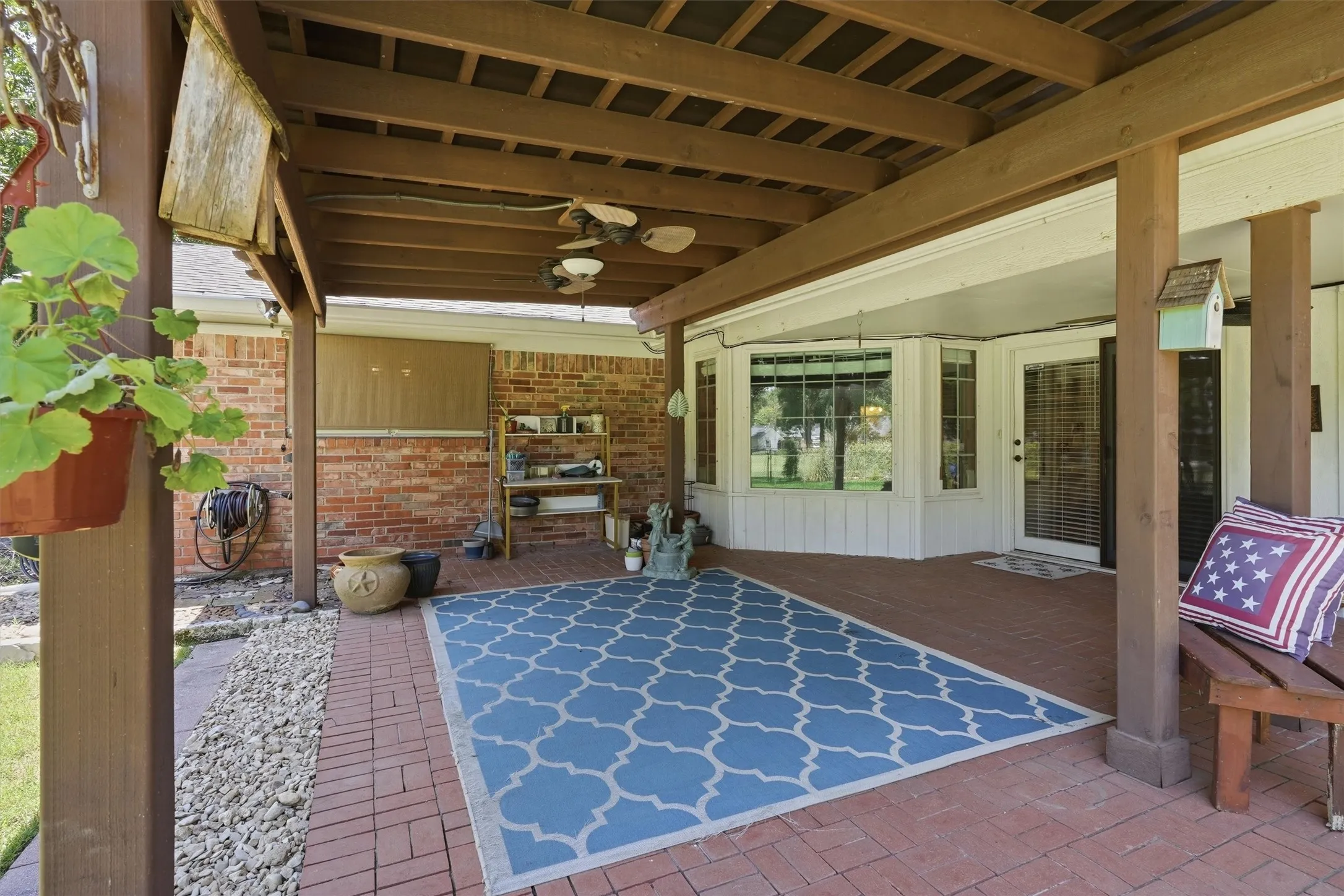 Covered patio featuring a wood beam ceiling and brick​​‌​​​​‌​​‌‌​‌‌​​​‌‌​‌​‌​‌​​​‌​​ flooring