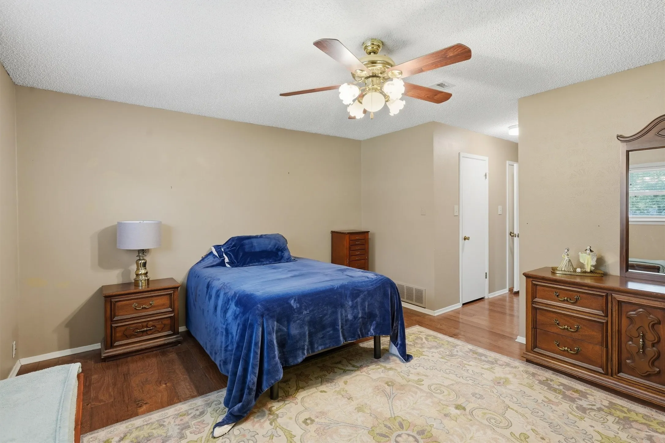 Bedroom featuring wood flooring and neutral wall tones
