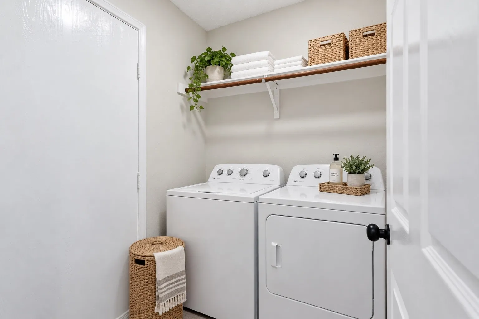 Dedicated laundry area featuring a white top-load washer and front-load dryer
