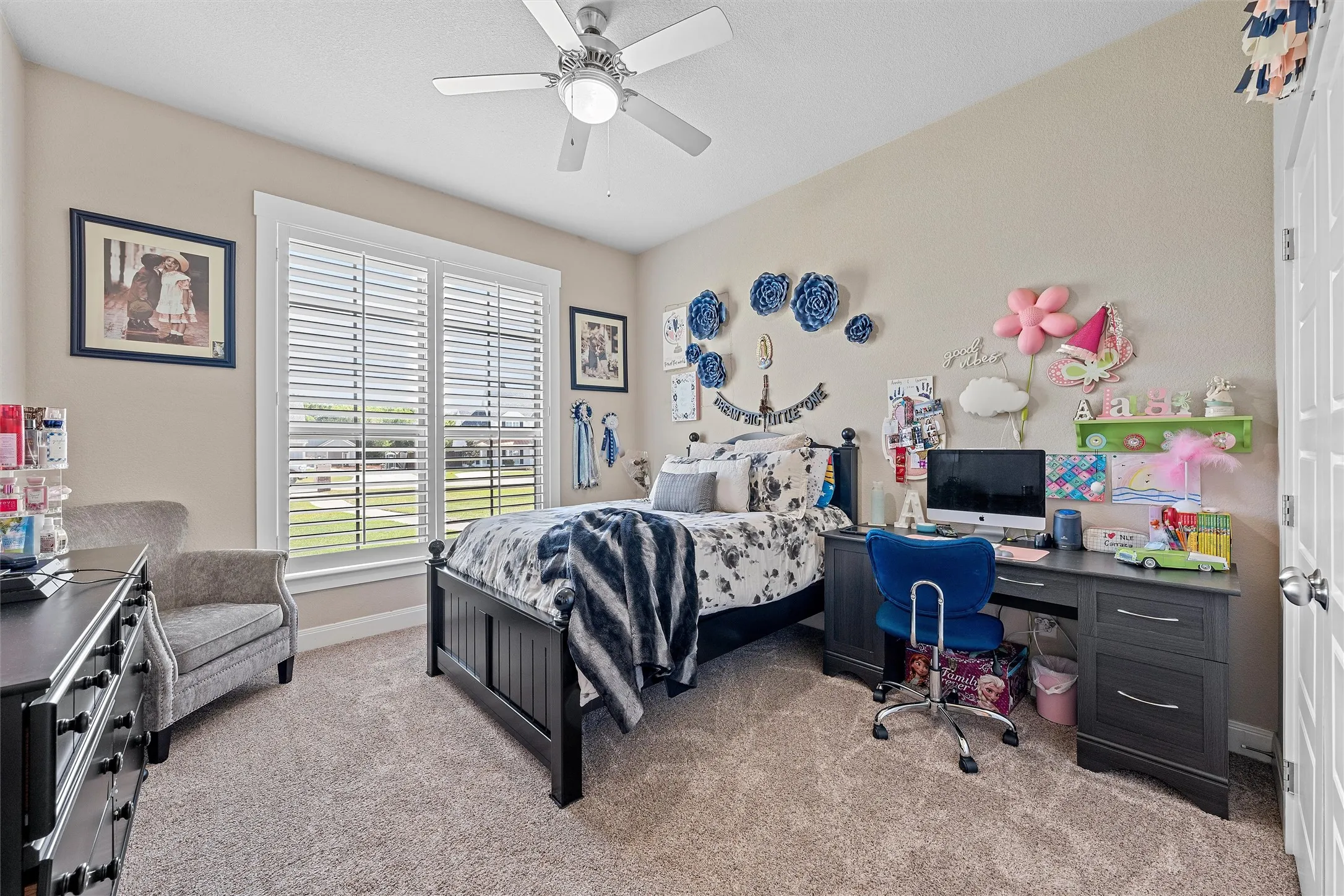 Carpeted interior room featuring a ceiling fan with light fixture
