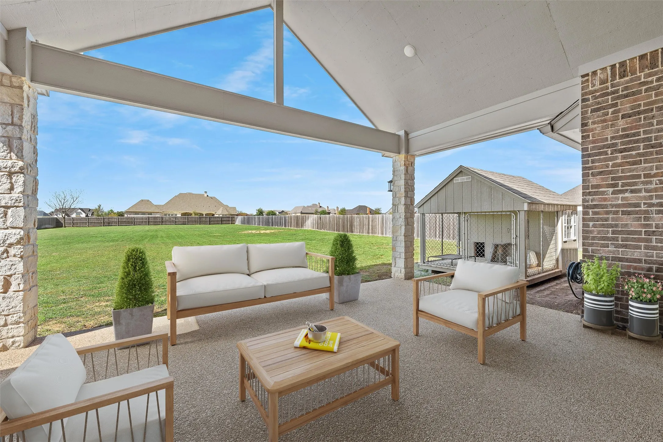 Covered outdoor patio featuring a vaulted ceiling and exposed structural beams