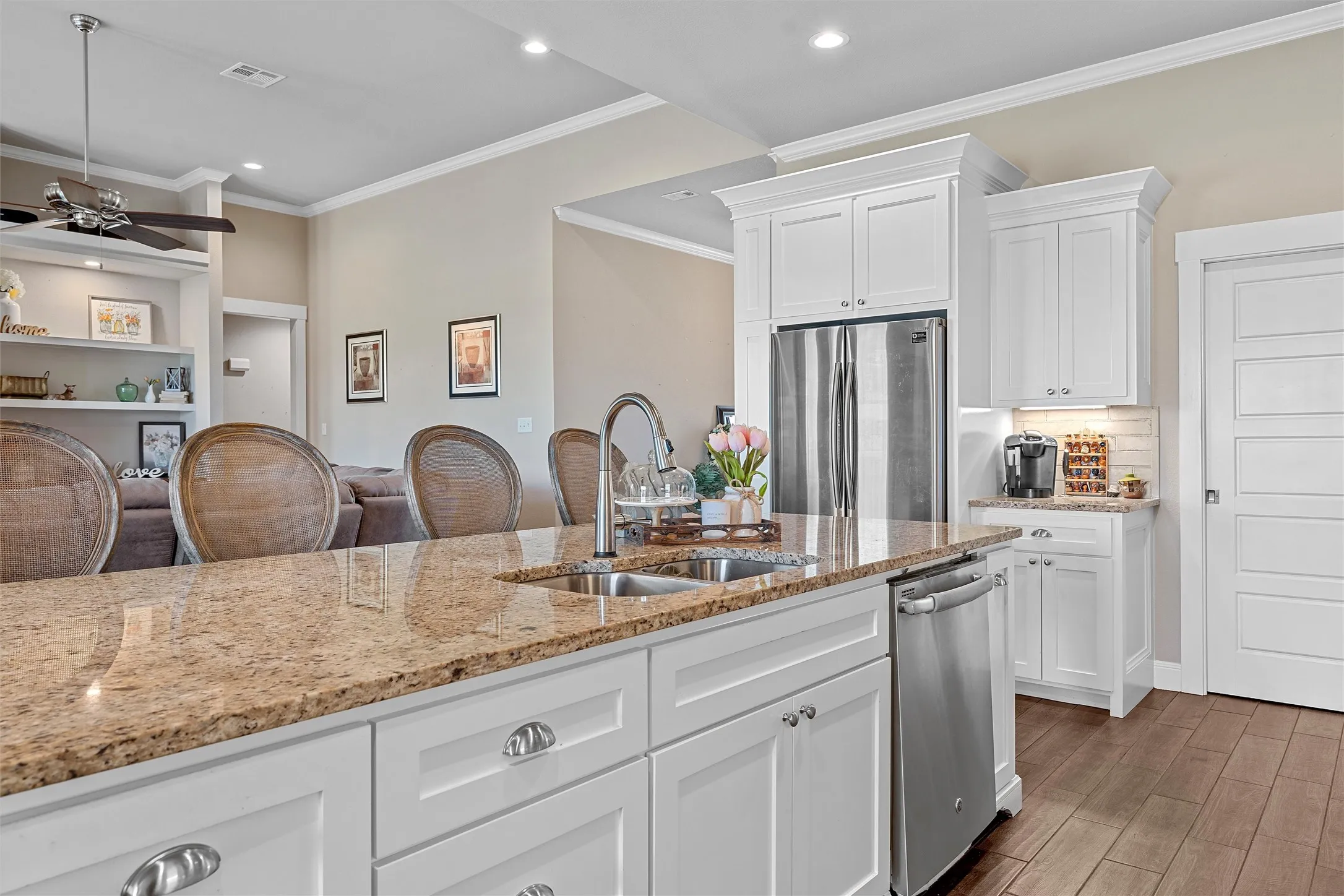Kitchen island featuring a double-basin sink and a gooseneck faucet