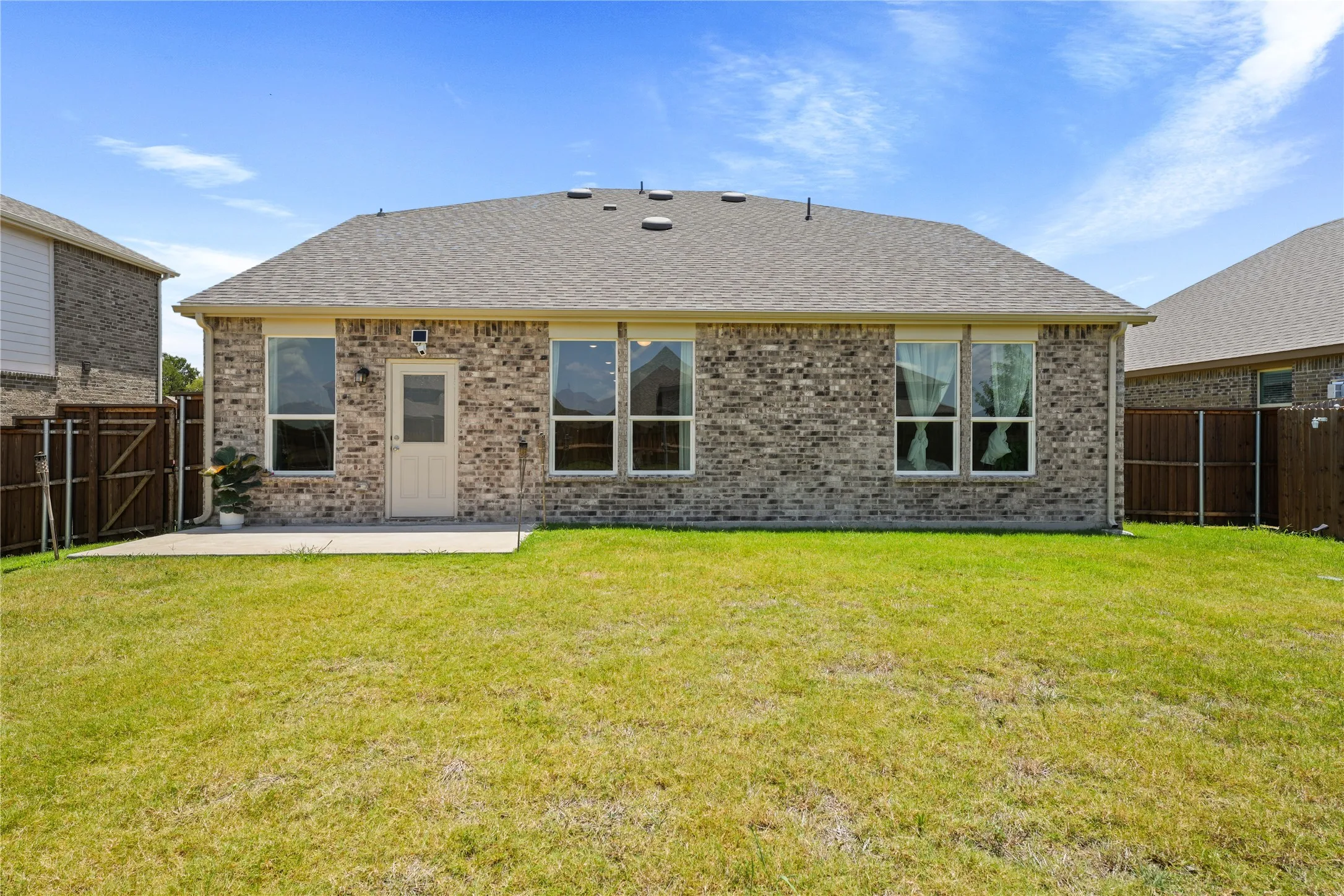 Rear view of house featuring a yard and a patio area