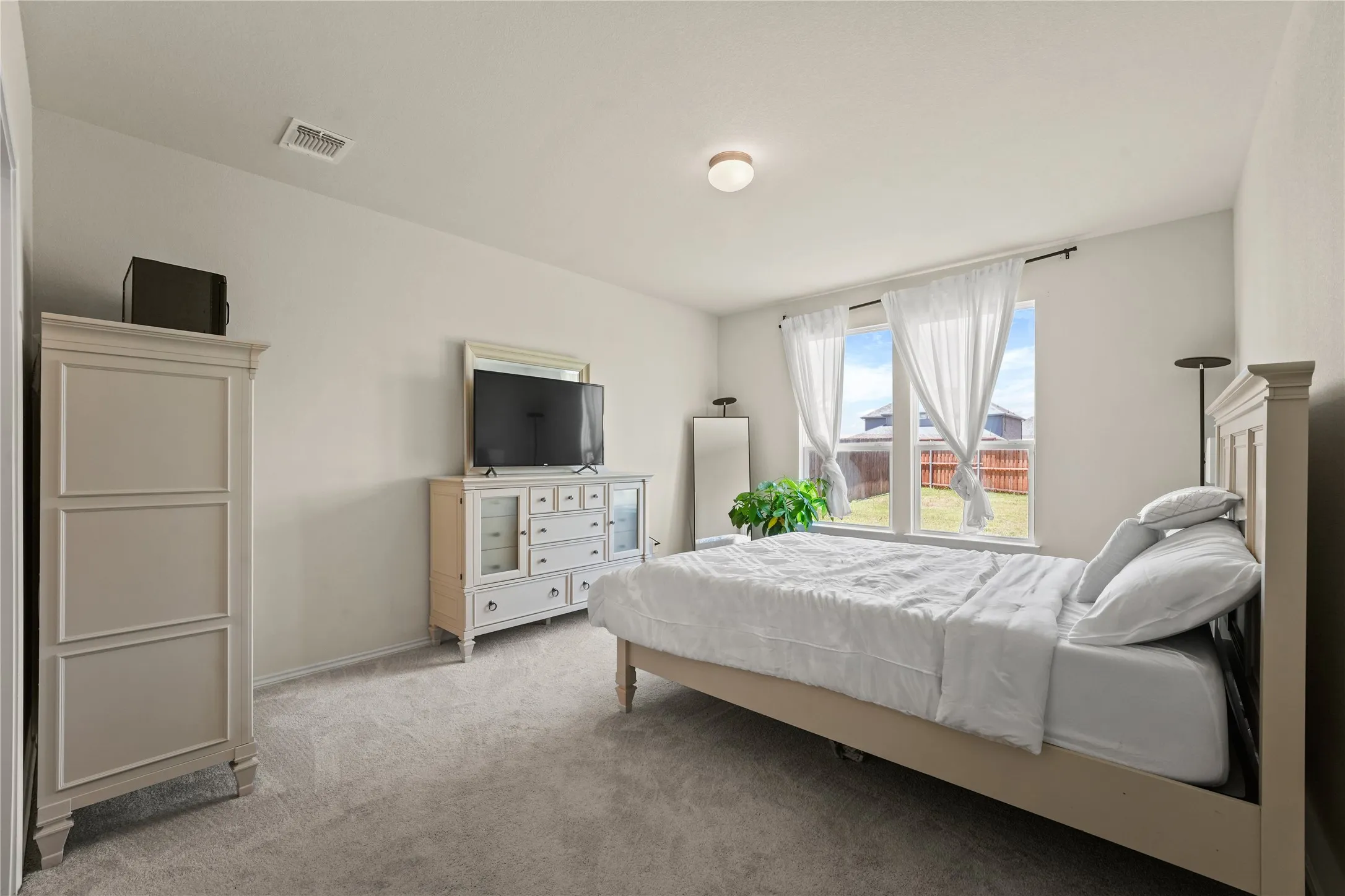 Bedroom with light carpet