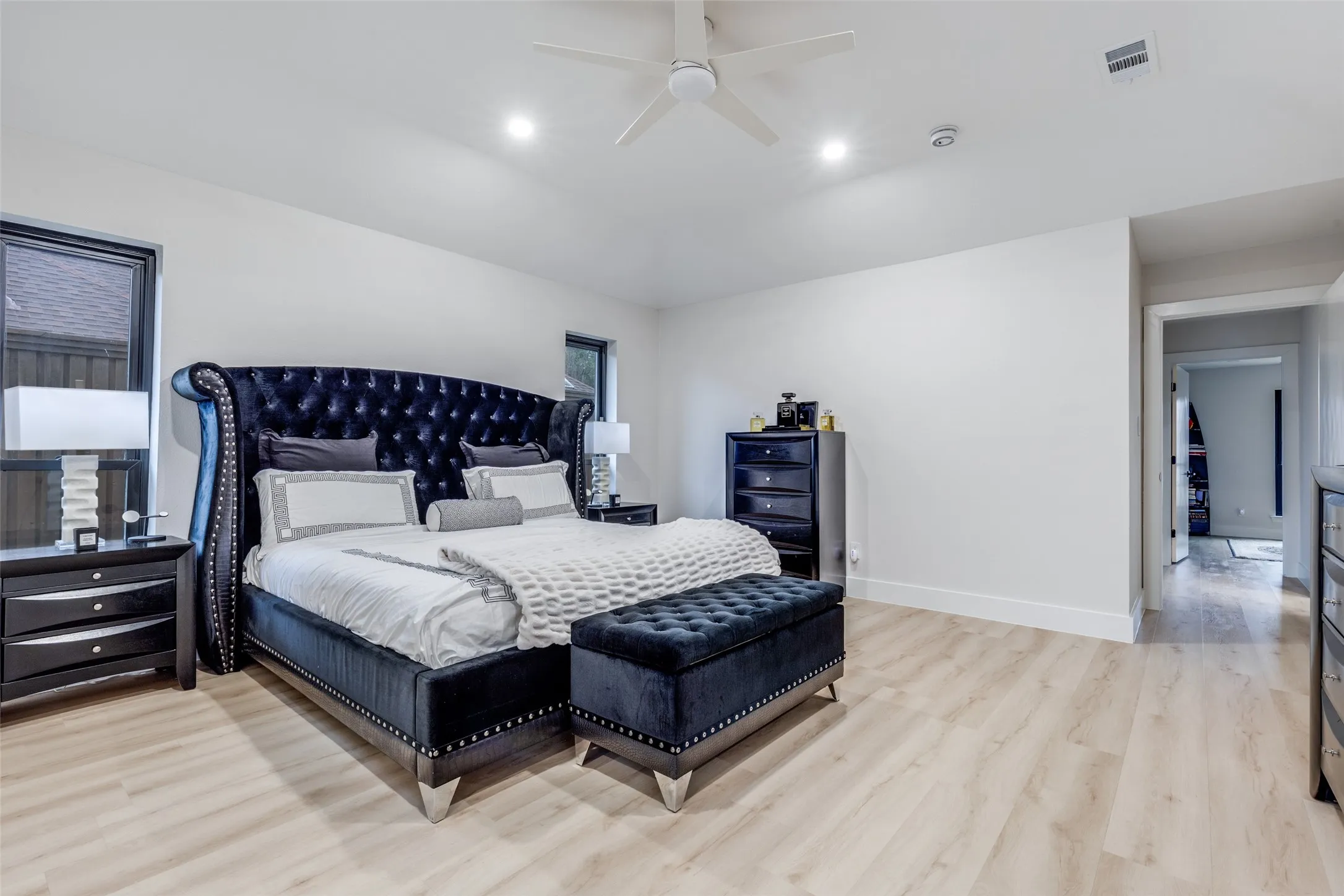 This primary bedroom offers relaxation and sophistication, all wrapped up into one.