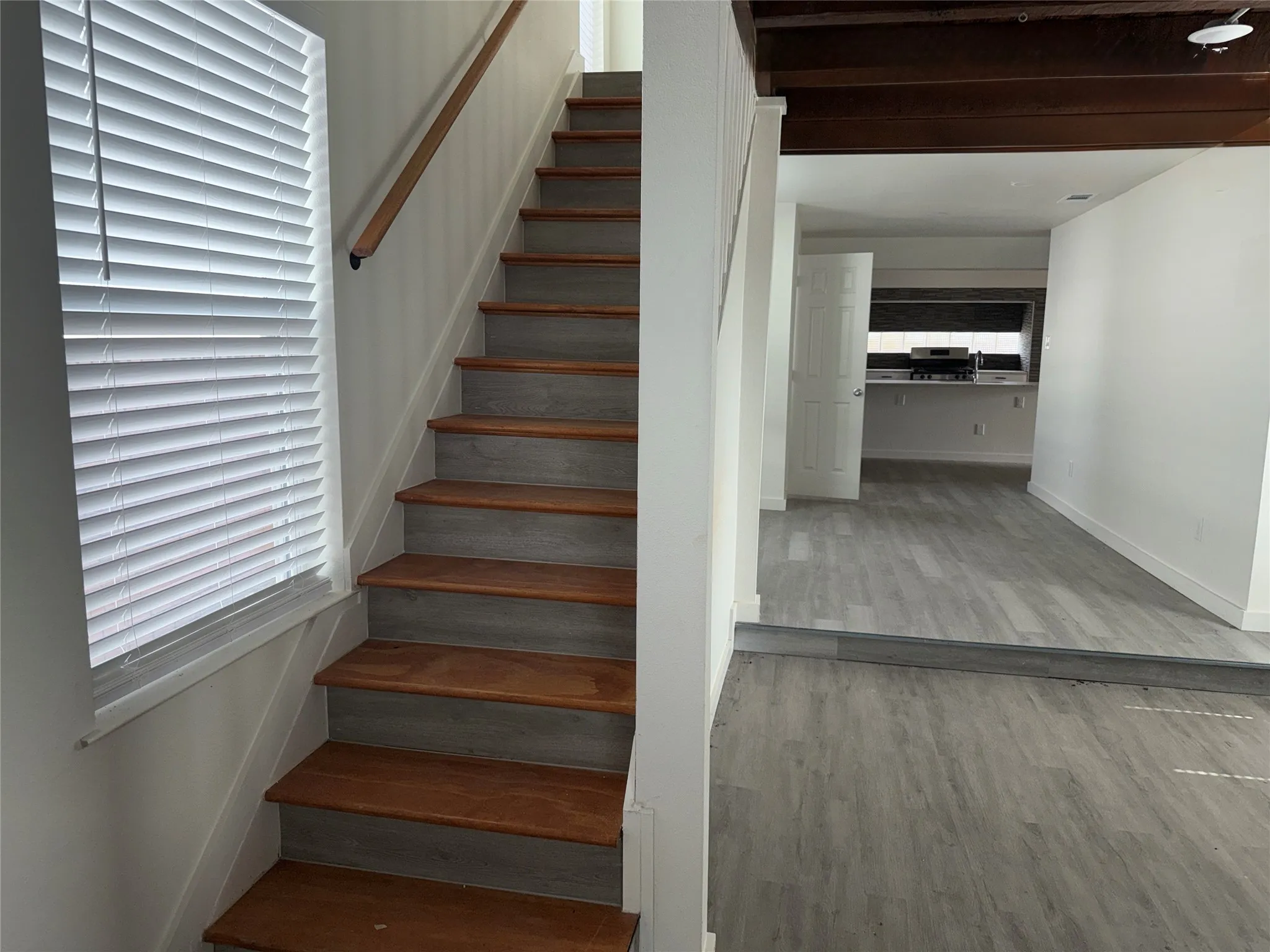 Stairs leading to three bedrooms, three baths upstairs, off living area #2