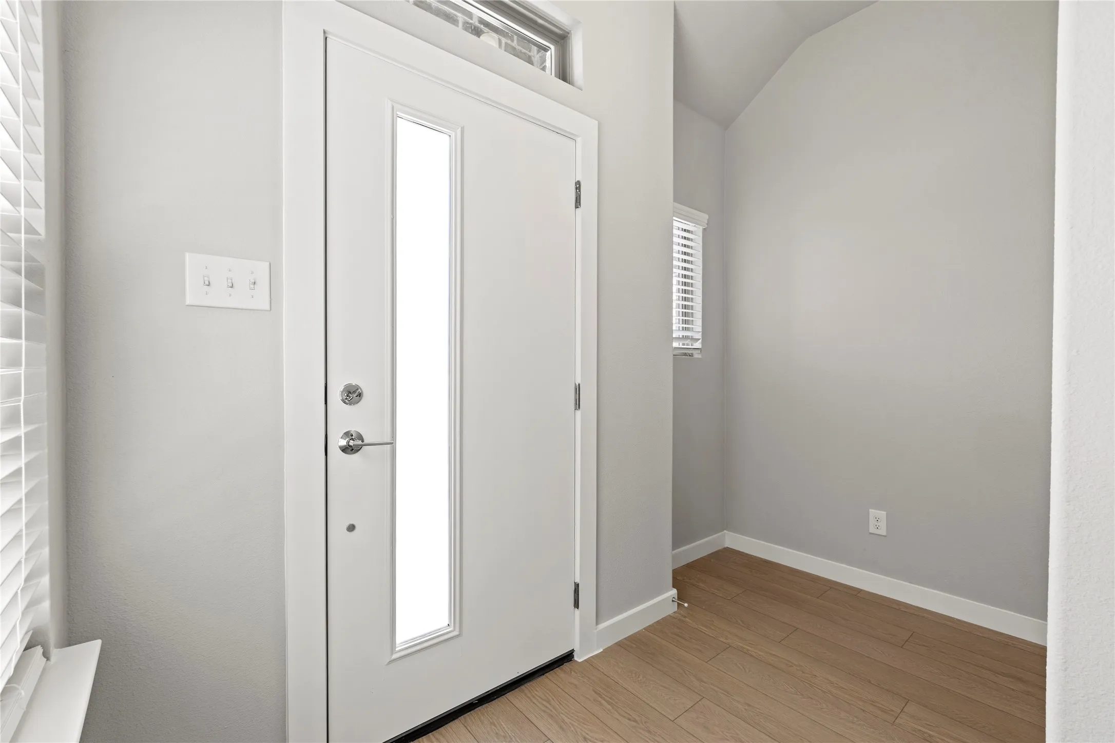 Foyer with plenty of natural light and light hardwood / wood-style flooring