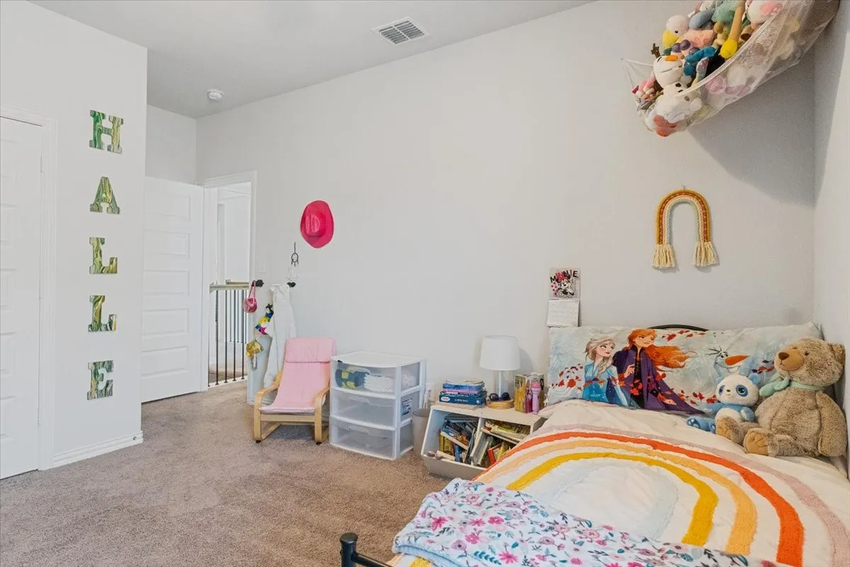 Carpeted bedroom with visible vents