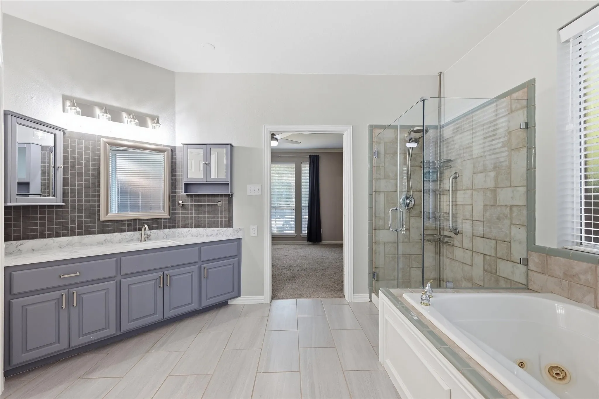 Dual vanity with undermount sinks, gray cabinetry, and a light-toned countertop