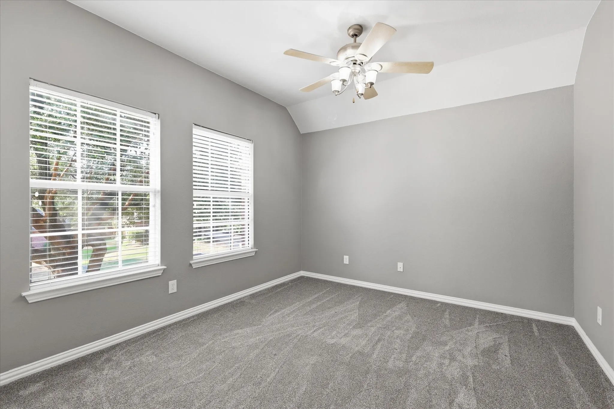 Gray carpeting with white baseboards
