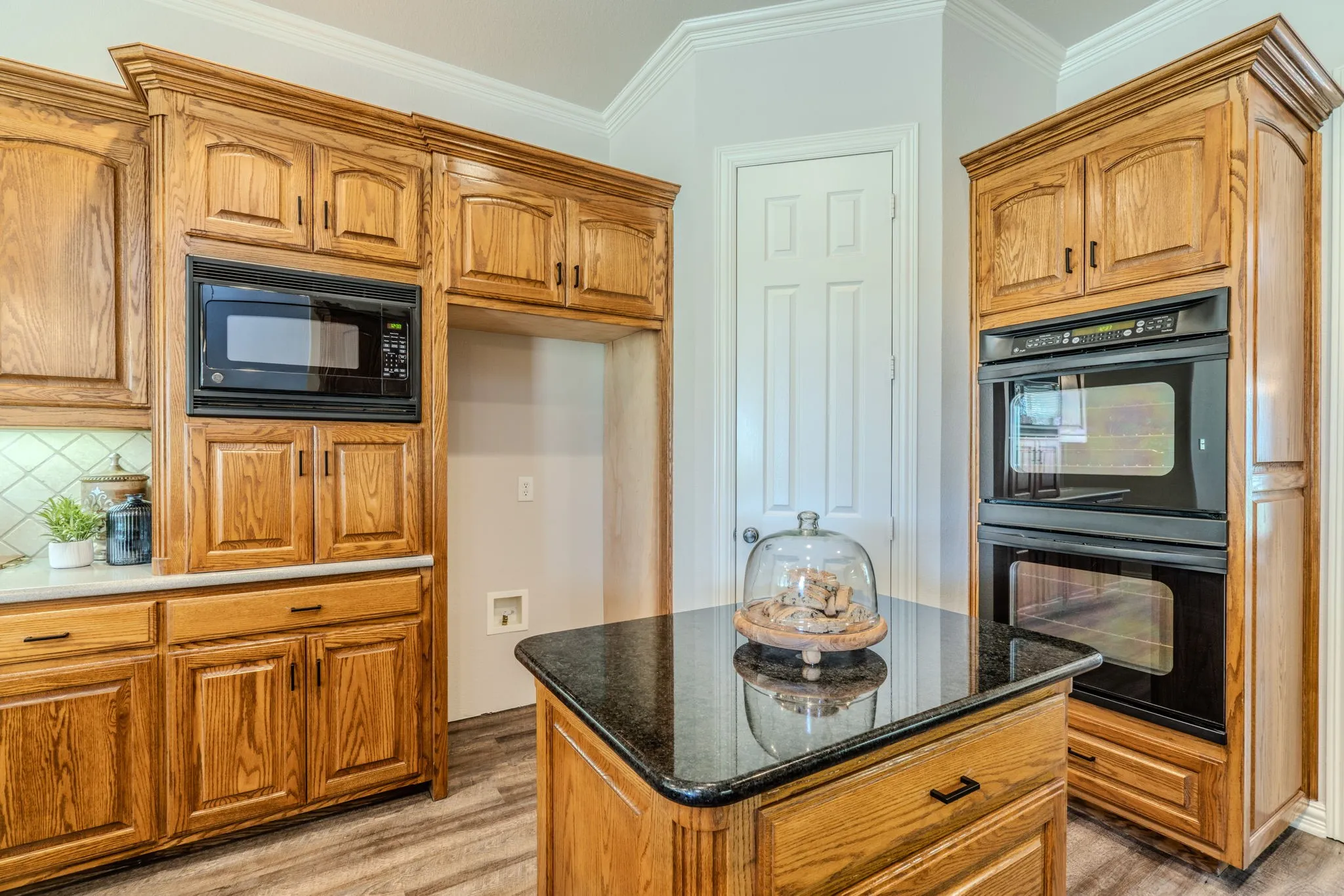 Kitchen island facing the double oven and HUGE pantry.