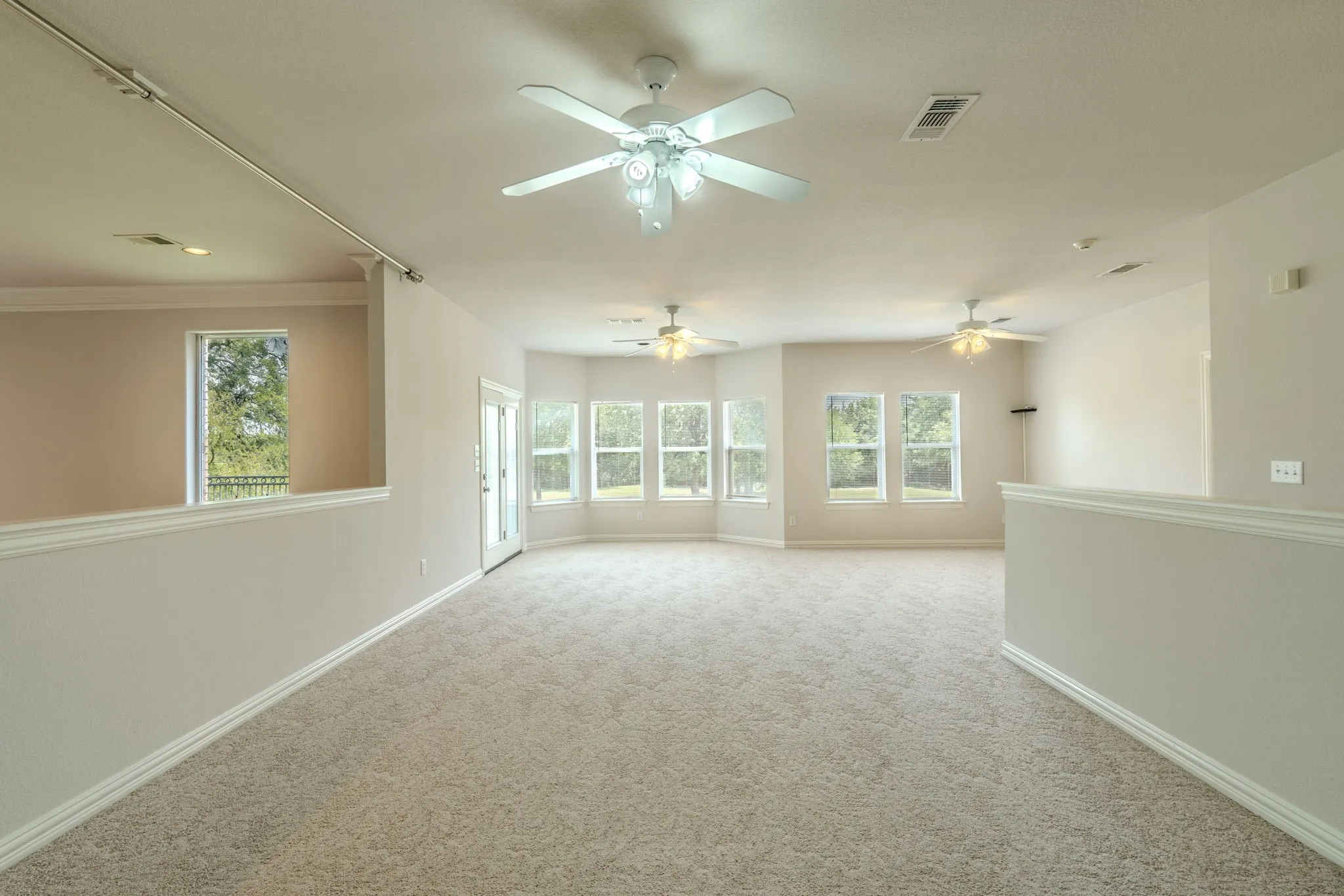 View of the loft area next to the game room area. So much room for entertaining here! Look at all those windows!