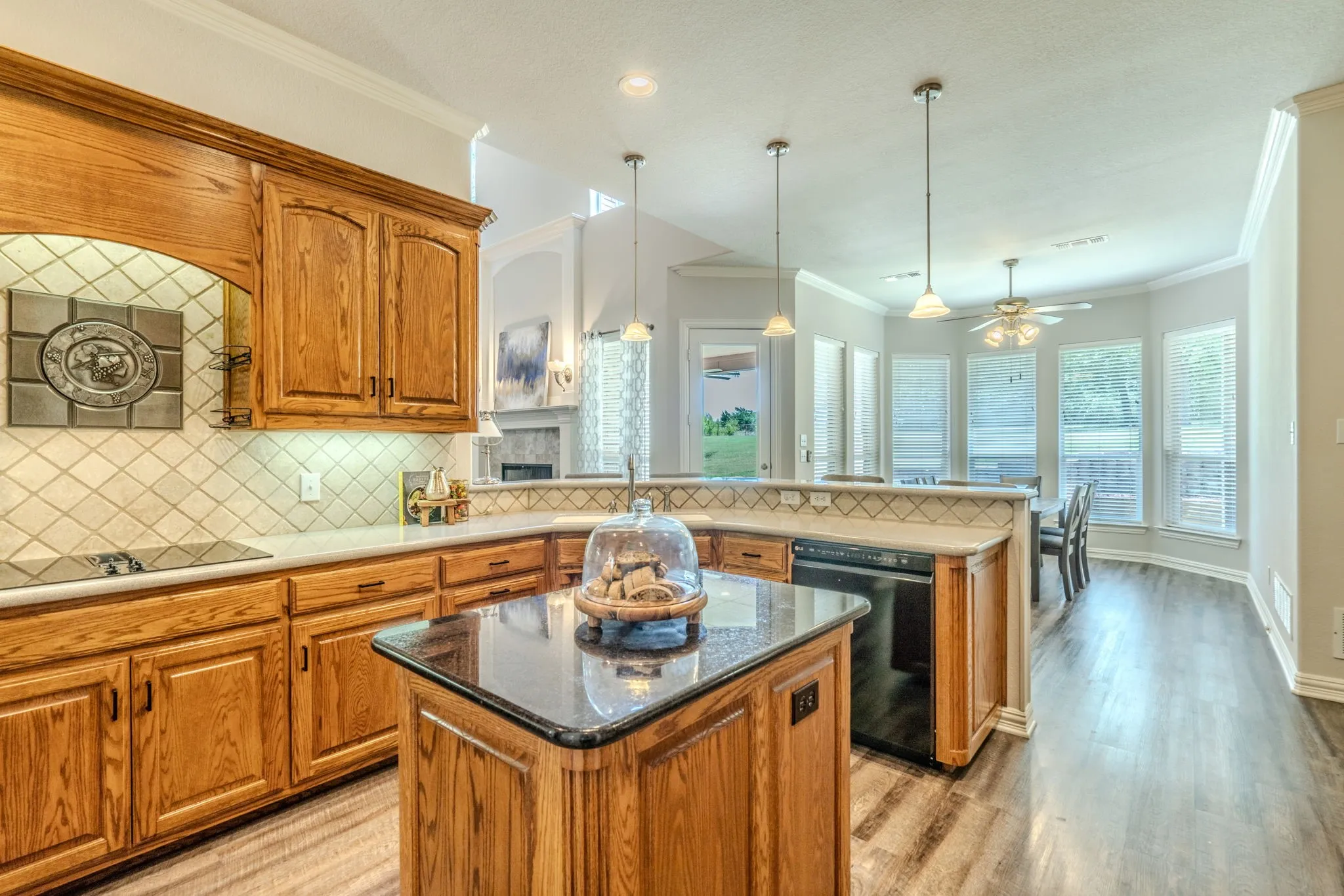 Kitchen island, tons of cooking and prep space with beautiful cabinetry facing the breakfast area with natural lighting.