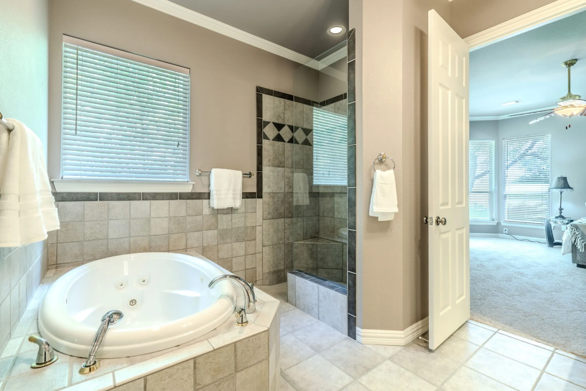Another view of the primary bathroom facing the inviting jetted tub and large shower.