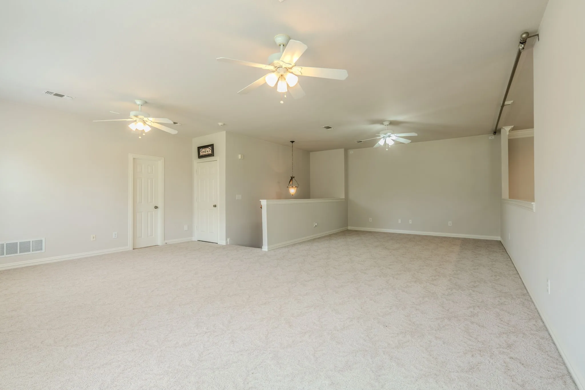 Upstairs game room area next to the loft area featuring ceiling fans, and tons of space for a pool table and hanging out!