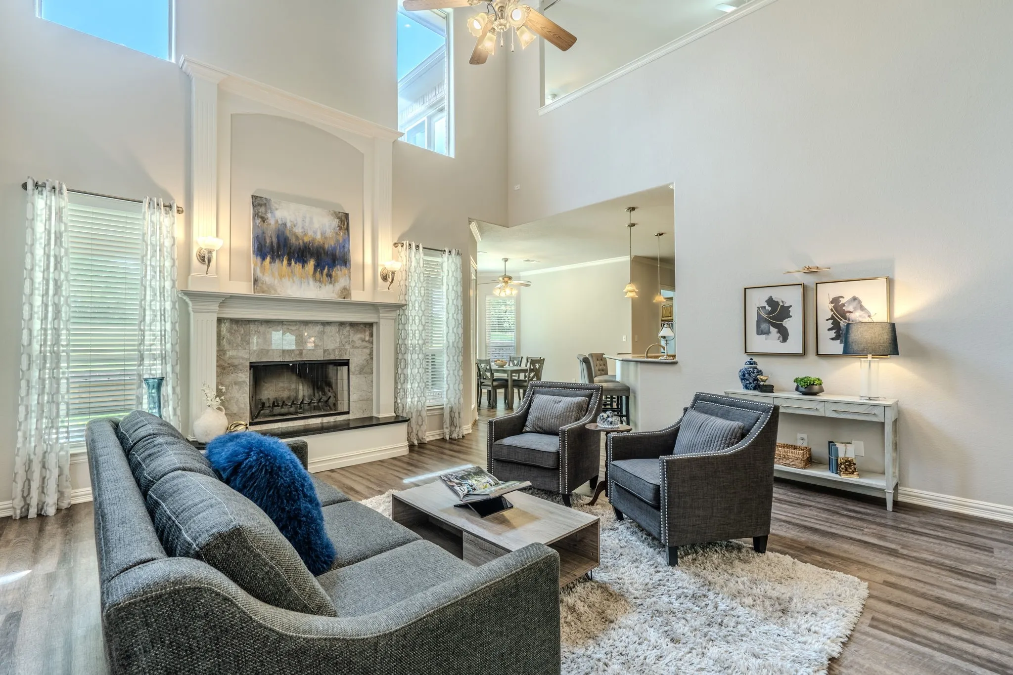 Huge living area with woodburning fireplace, cathedral ceilings, LVP flooring and tons of natural light.
