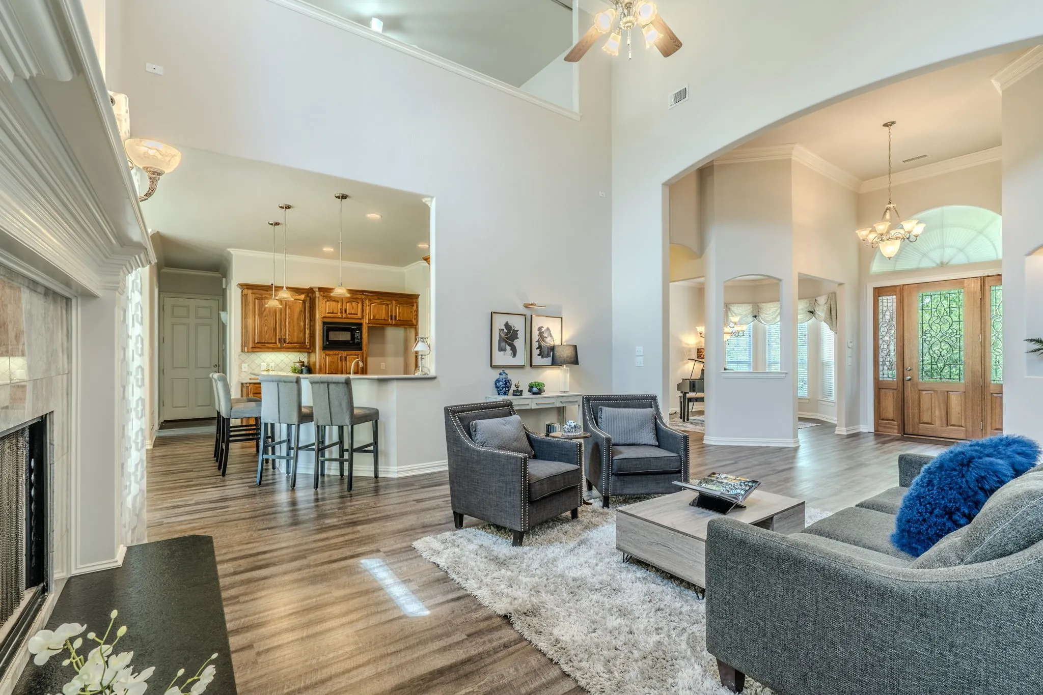 Another view of the spacious living area facing the breakfast bar, entryway, and formal dining room.