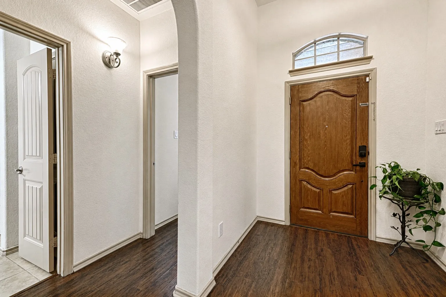 Rich wood-finish flooring extending from the entryway