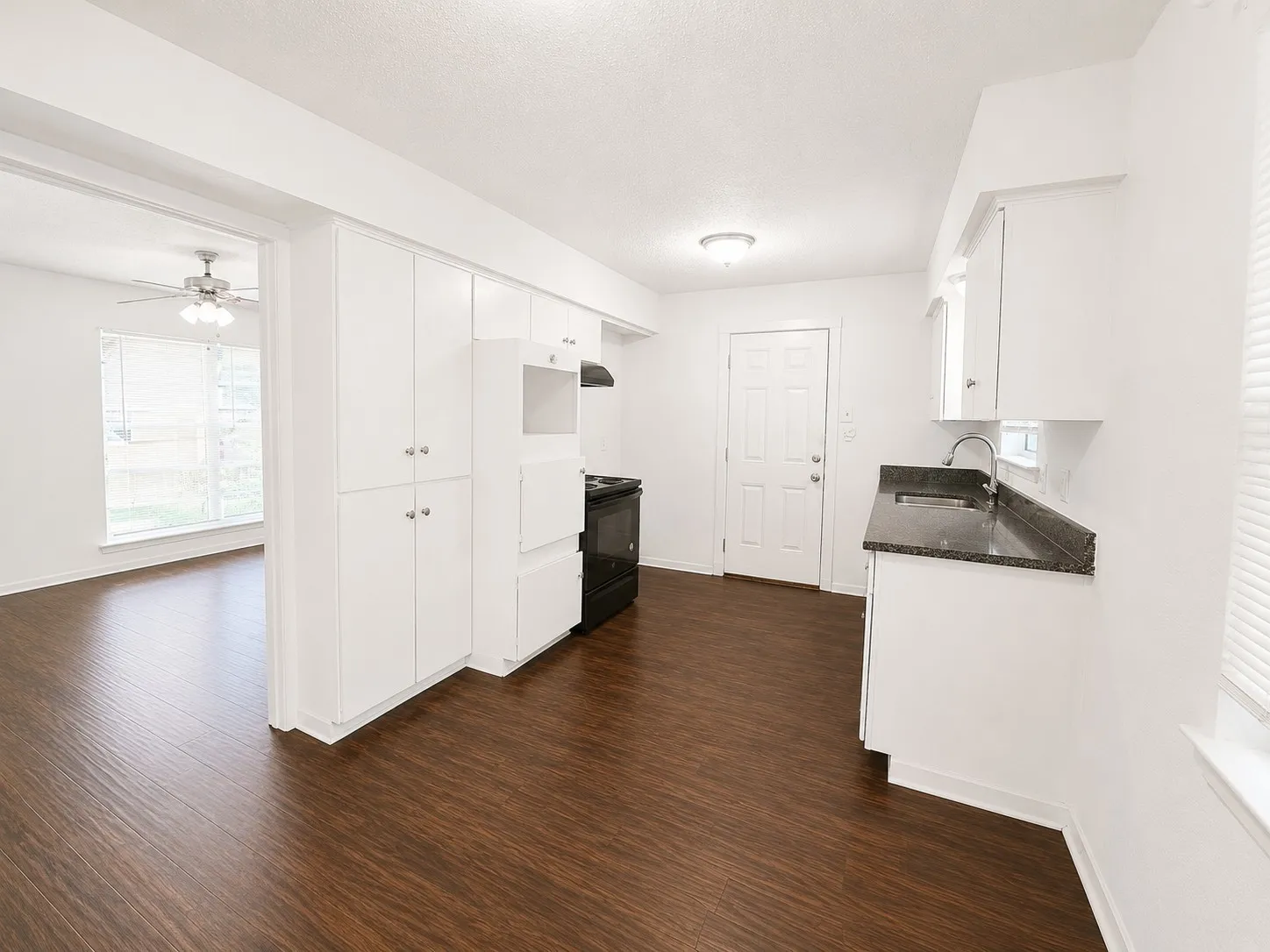Breakfast Area featuring dark wood-finish flooring next to the kitchen for convenience.