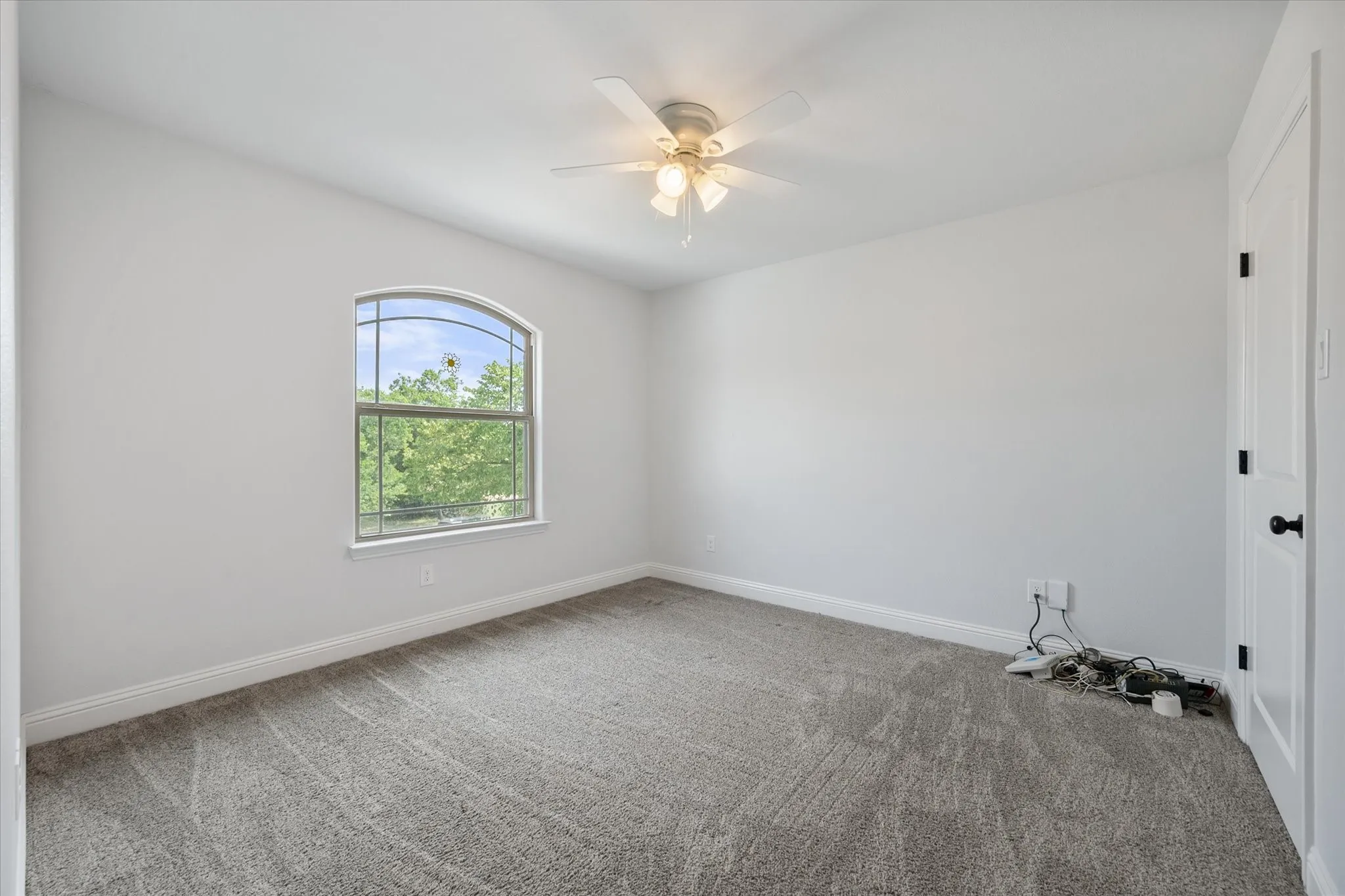 Bedroom 3 has ceiling fan and views of the front yard!