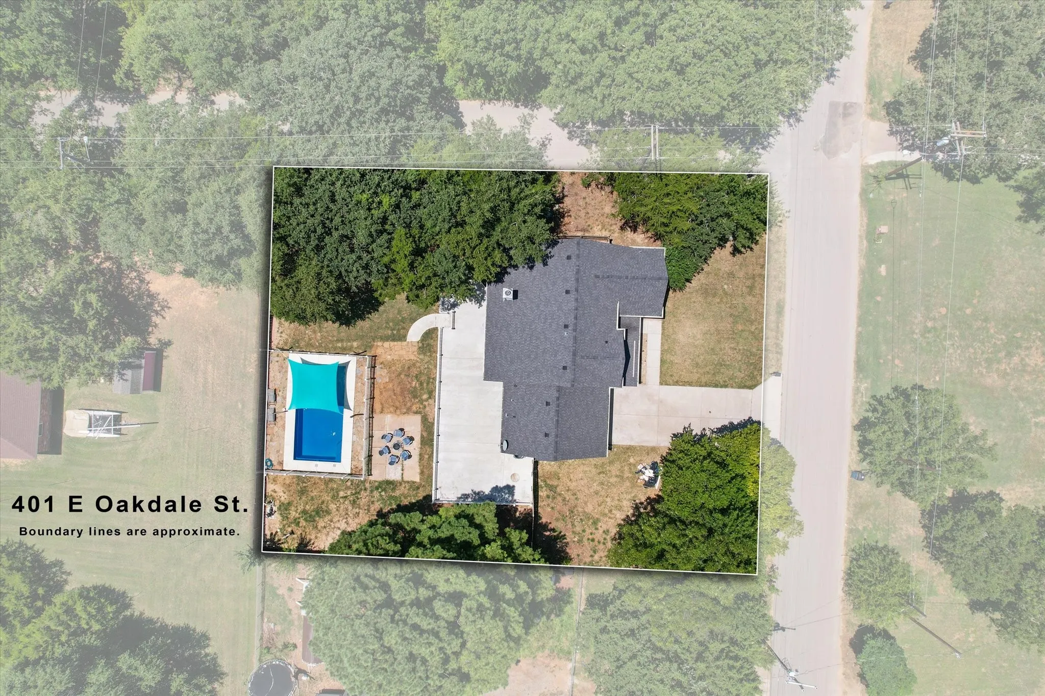 Aerial view showcasing the property with half acre lot, two story home, expansive concrete patio and inground swimming pool!