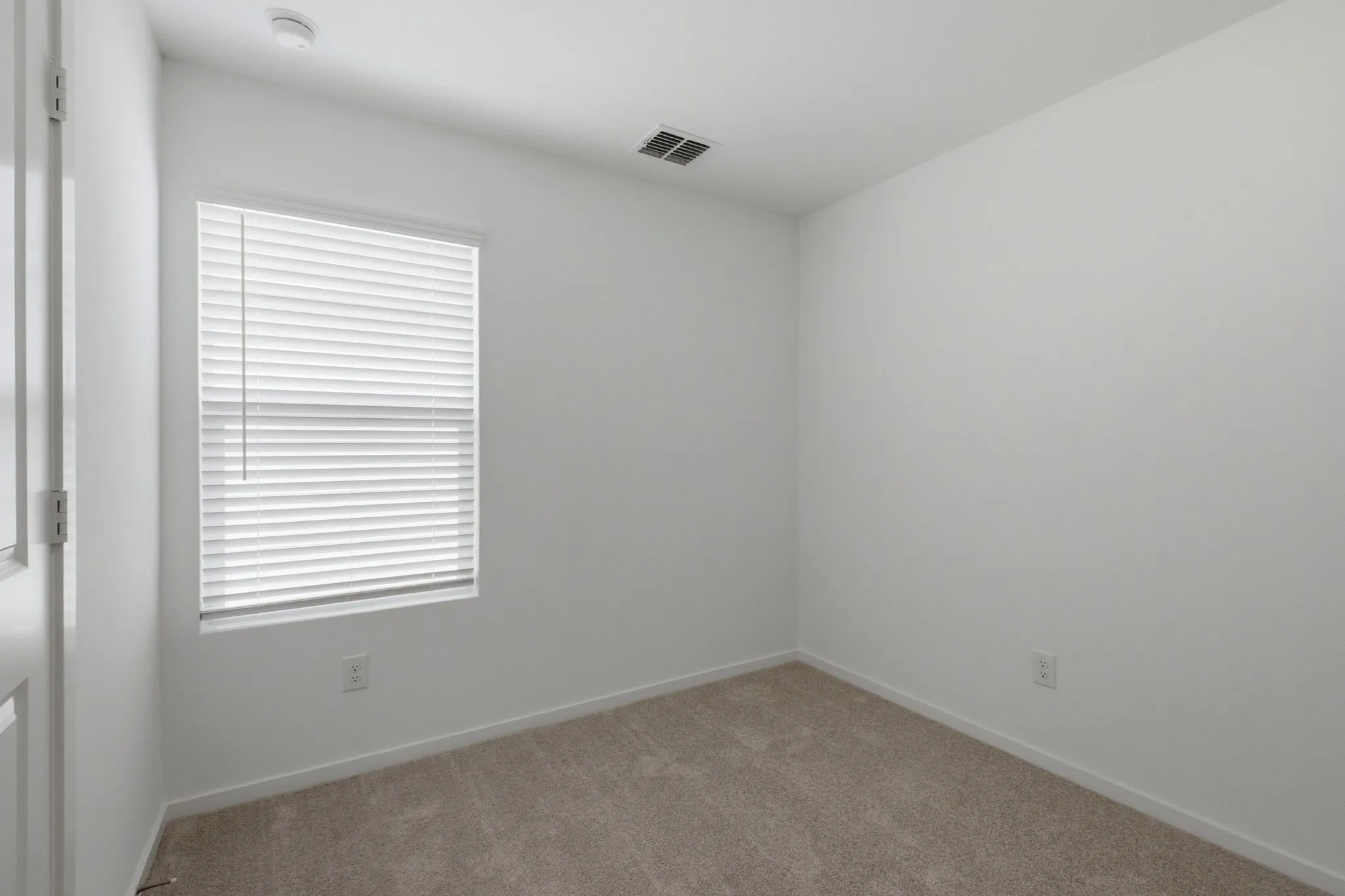Room featuring light-toned carpeting and neutral wall tones