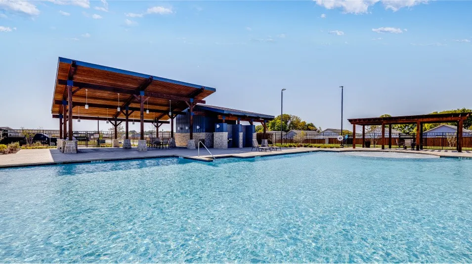 Community swimming pool with an expansive paver deck