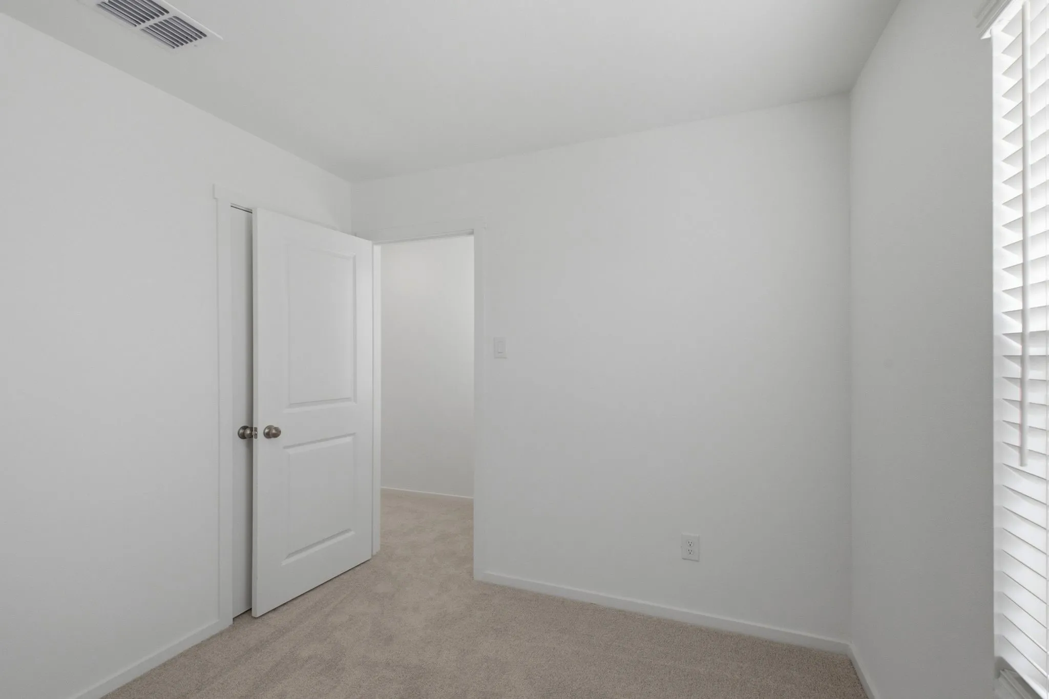Neutral wall paint and plush carpeting create a versatile interior space