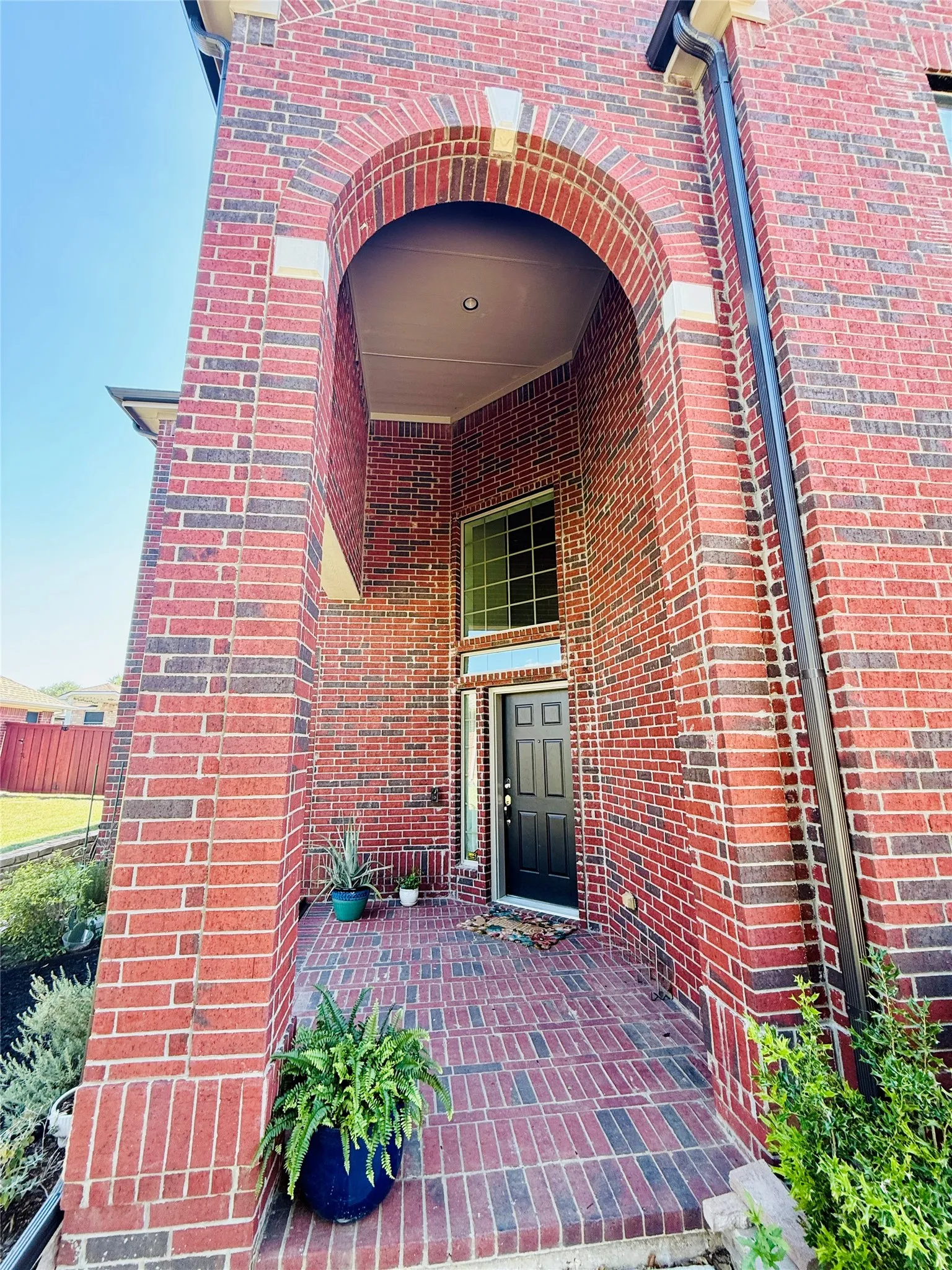 Brick exterior featuring an arched entryway