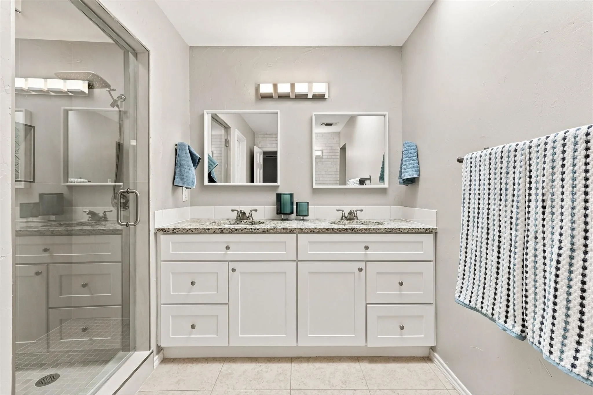 Dual vanity with white cabinetry and integrated sinks