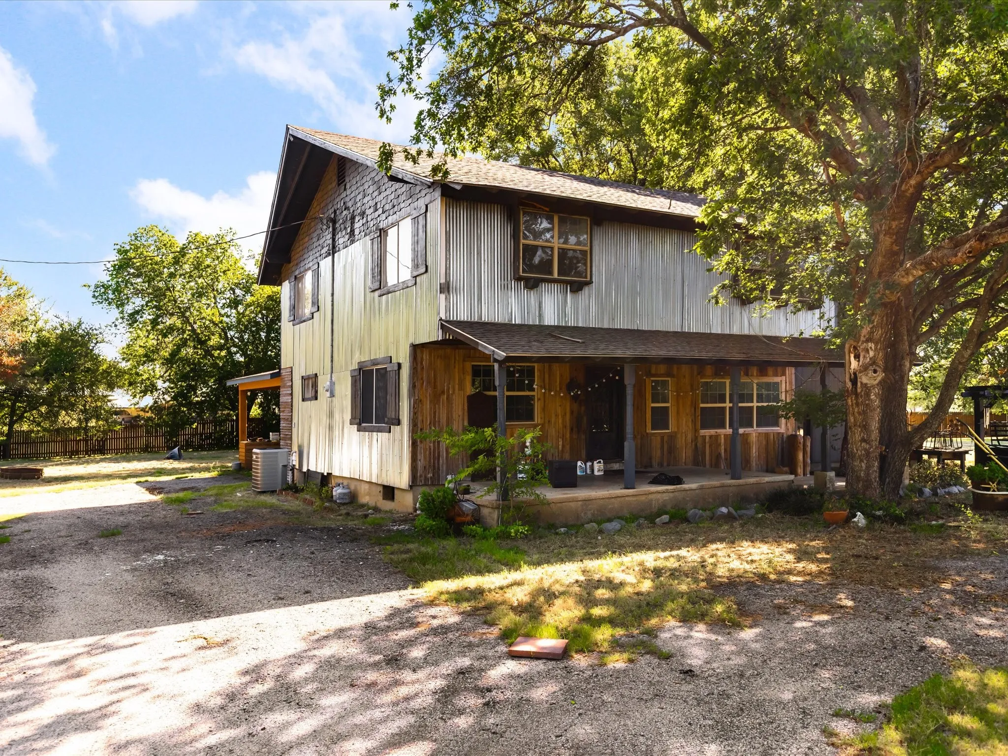 Two-story residence featuring a combination of vertical wood-finish siding and horizontal wood paneling