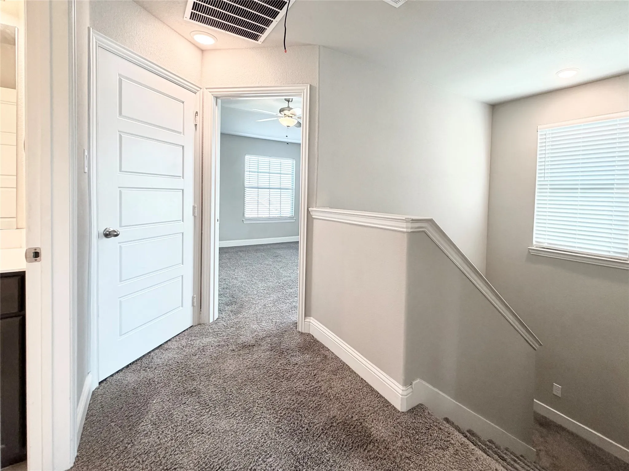 Upstairs landing, view into the primary suite
