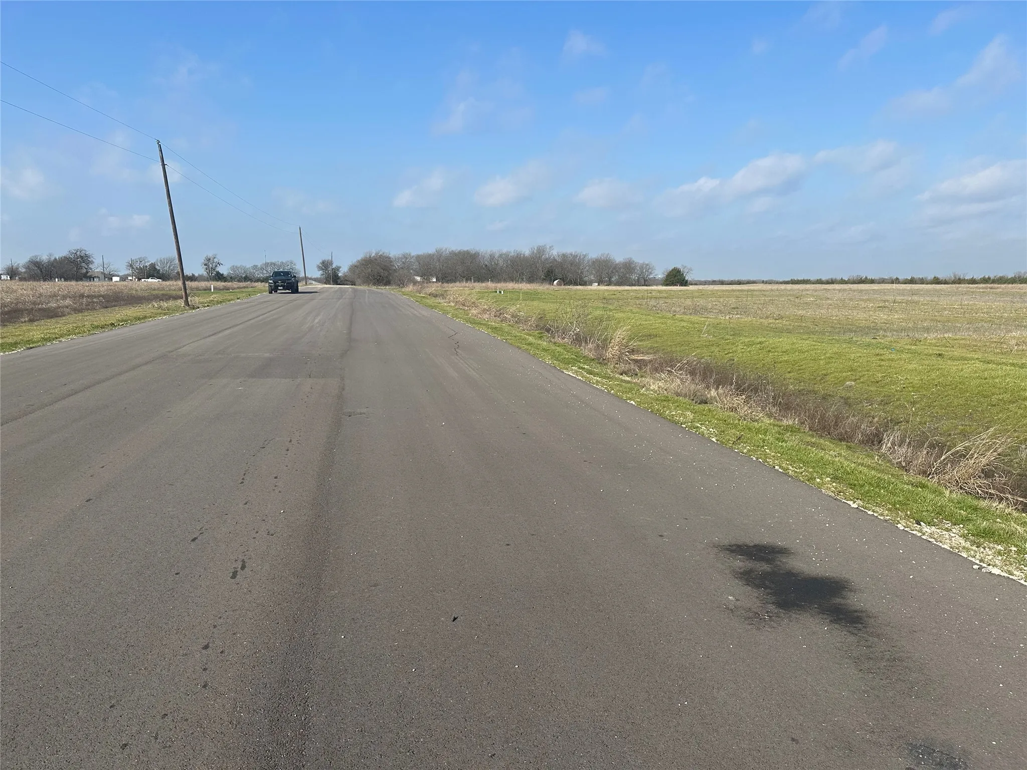 Paved road frontage with utility poles