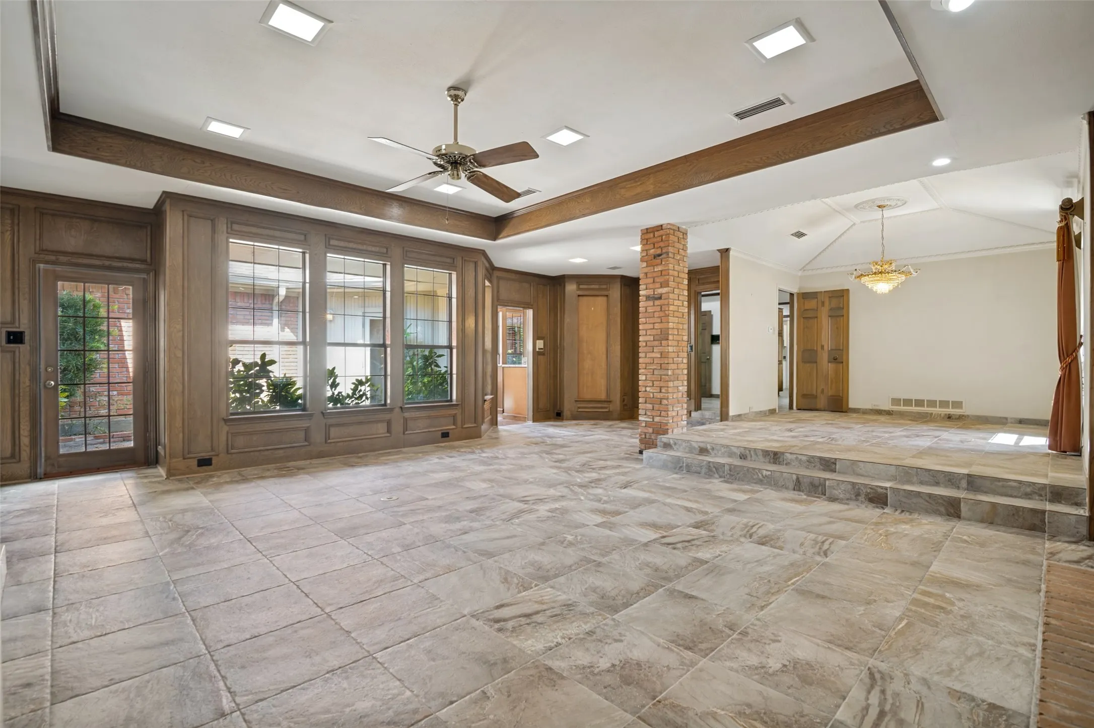 Unfurnished Furnished Living and Dining Room. Doorway right of the windows opens to the wet bar area.