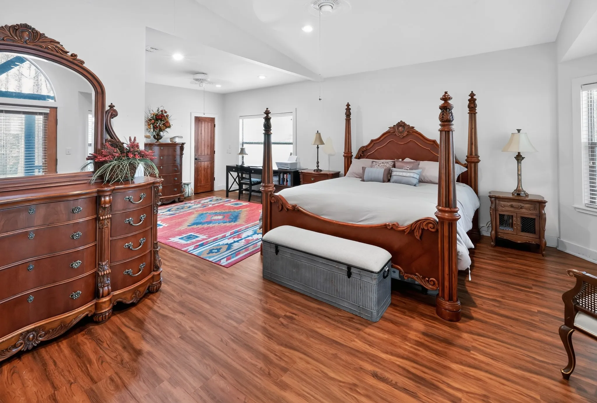 Spacious master suite featuring a private sitting area and tranquil views of the community lake.