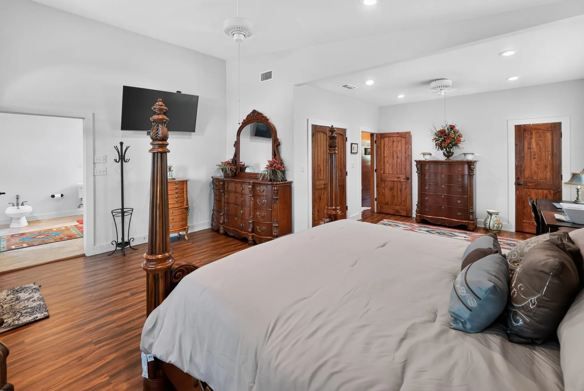 Spacious master suite featuring a private sitting area and tranquil views of the community lake.