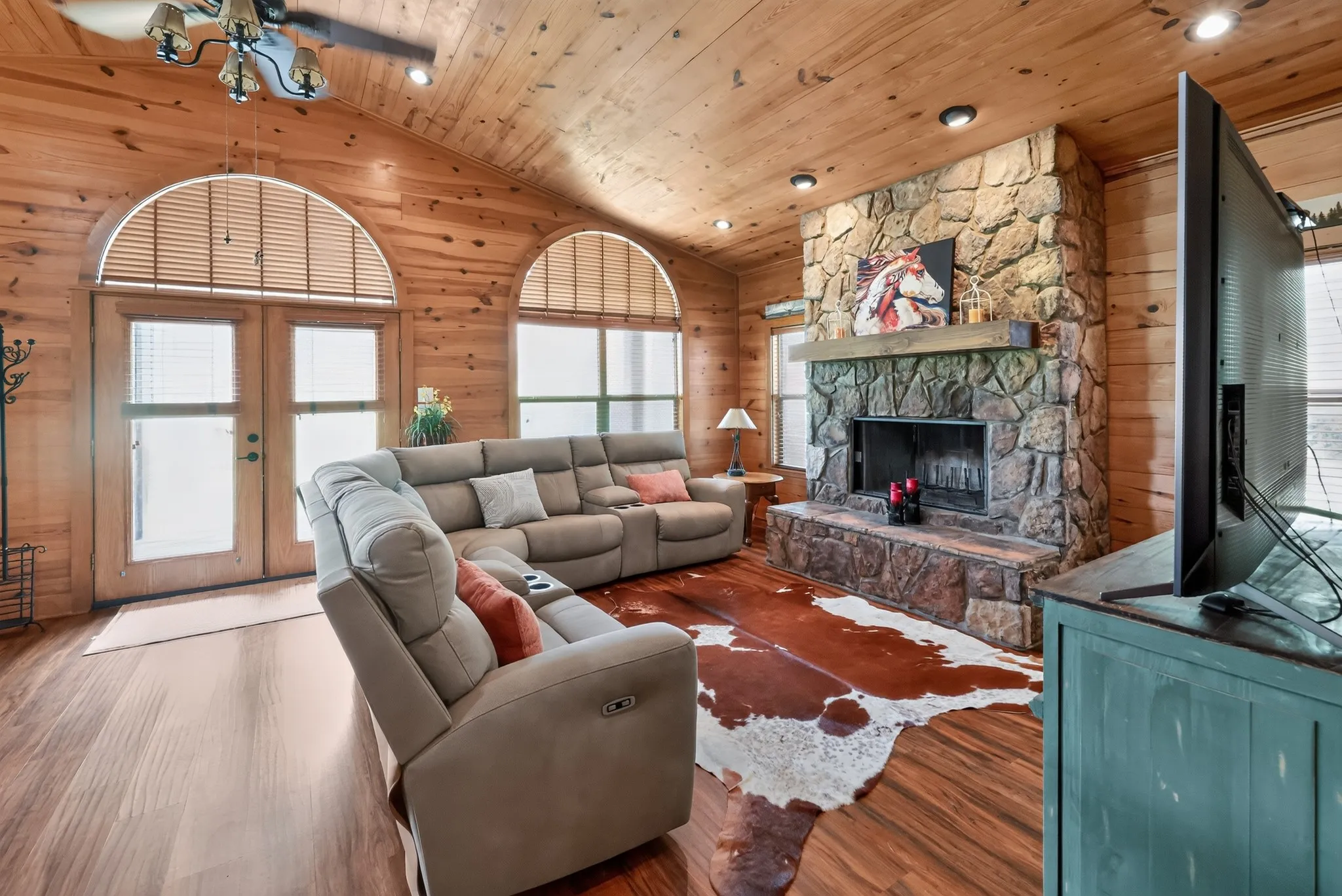 Open-concept living room highlighted by a stunning wood-burning fireplace.