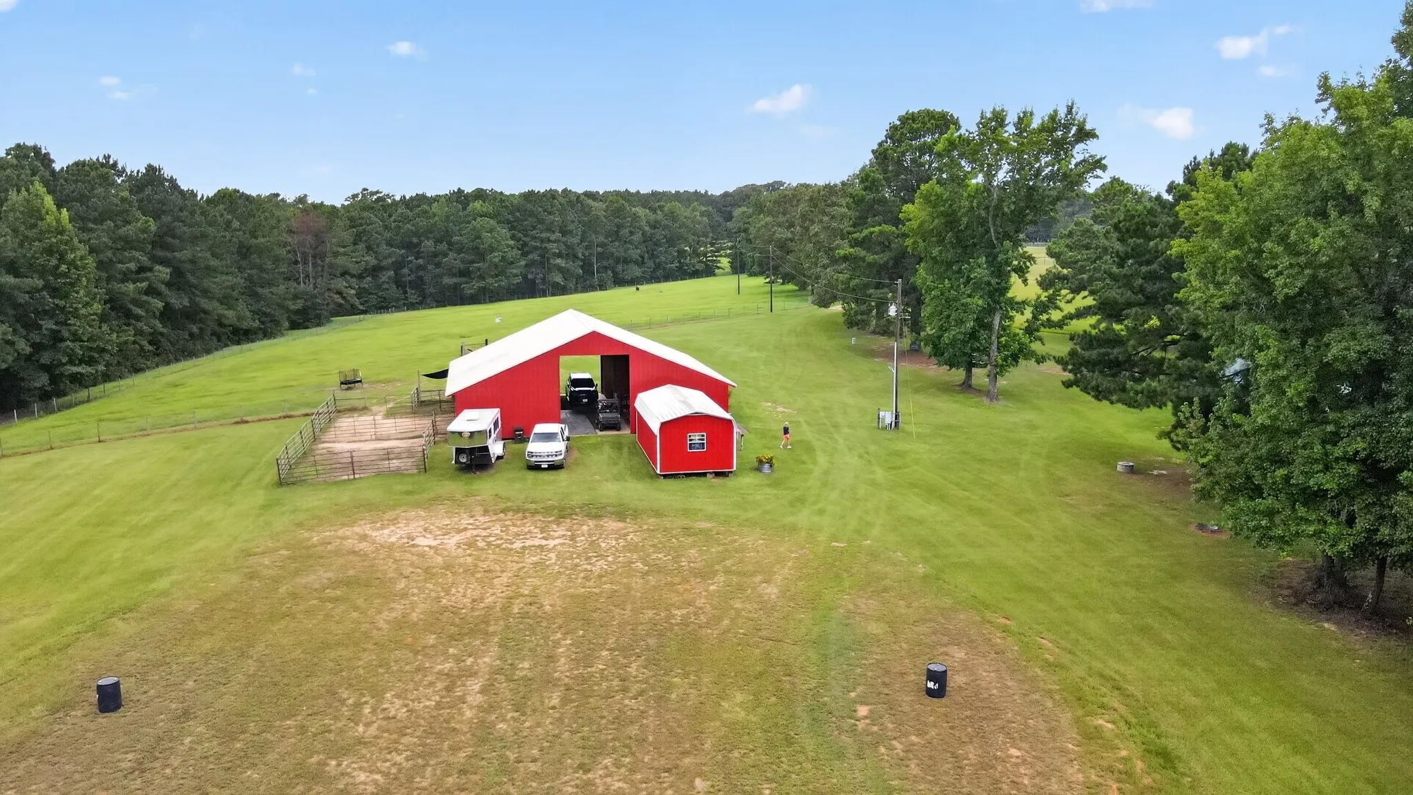 Aerial view showcasing the horse barn and workshop/storage building.