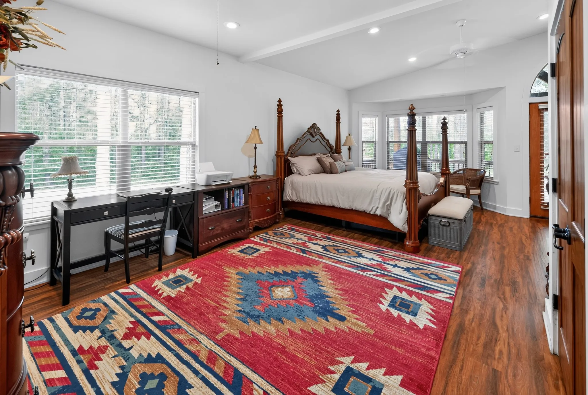 Spacious master suite featuring a private sitting area and tranquil views of the community lake.
