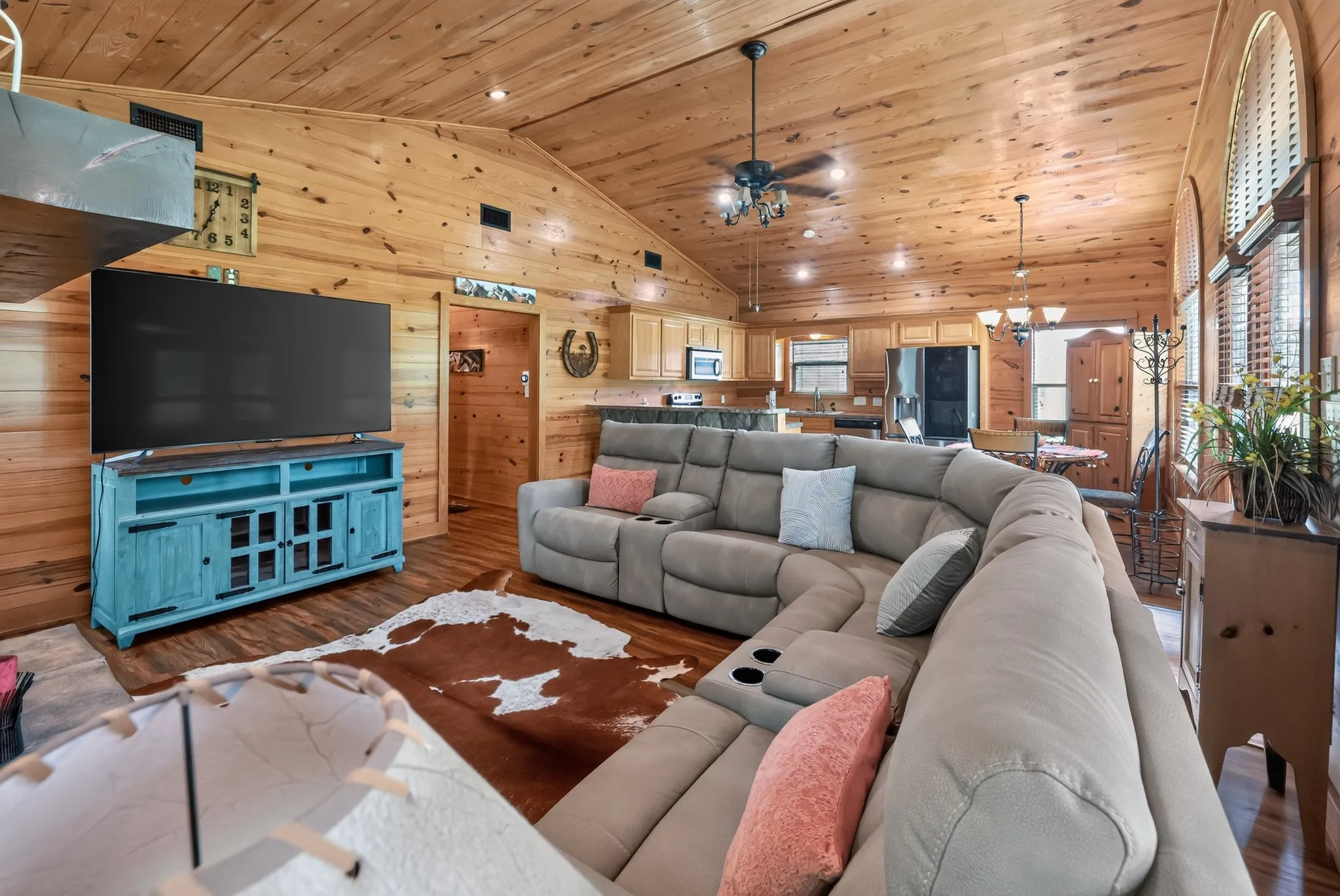 Open-concept living room highlighted by a stunning wood-burning fireplace.