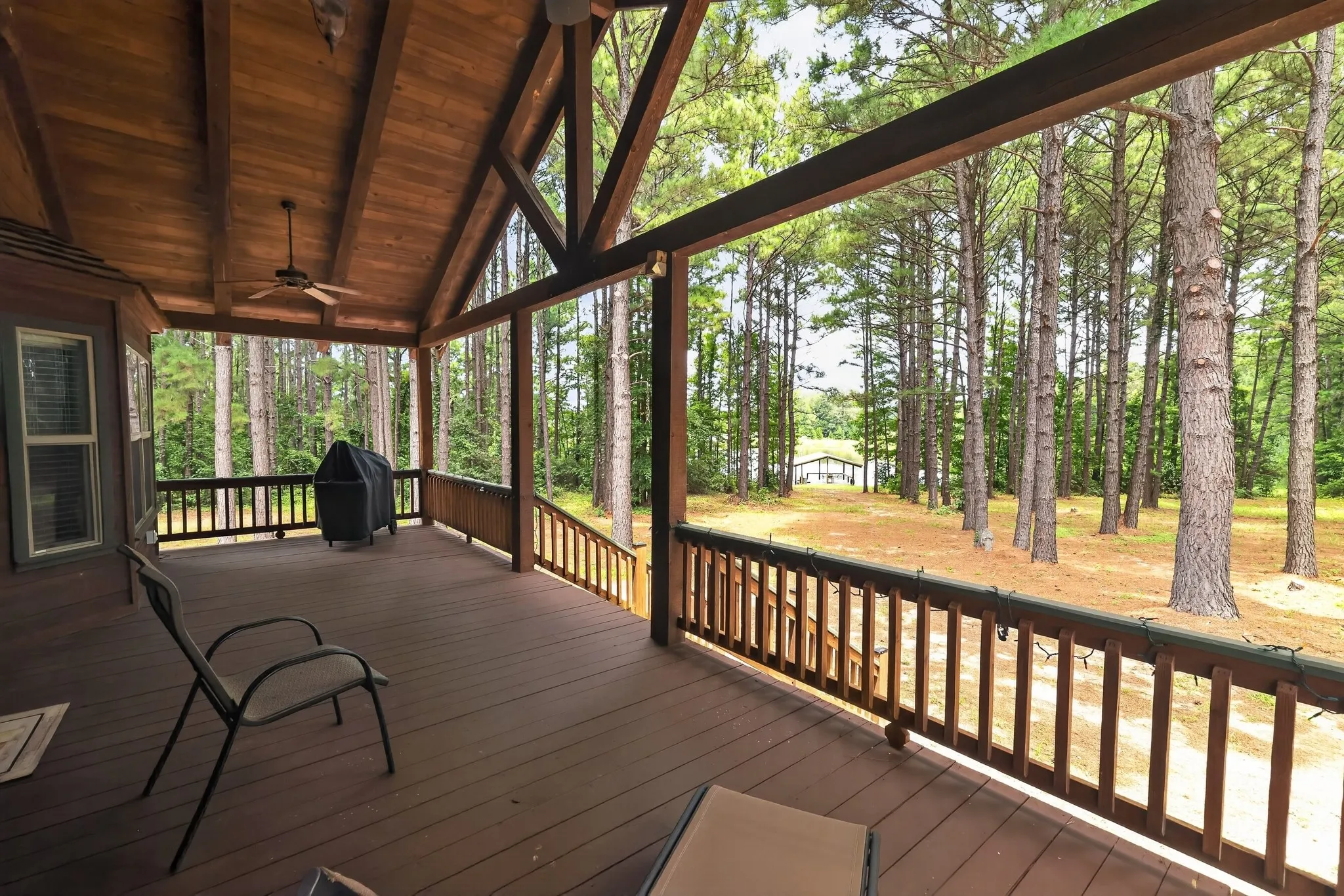 Relax on the covered back porch while taking in peaceful views of the community lake.