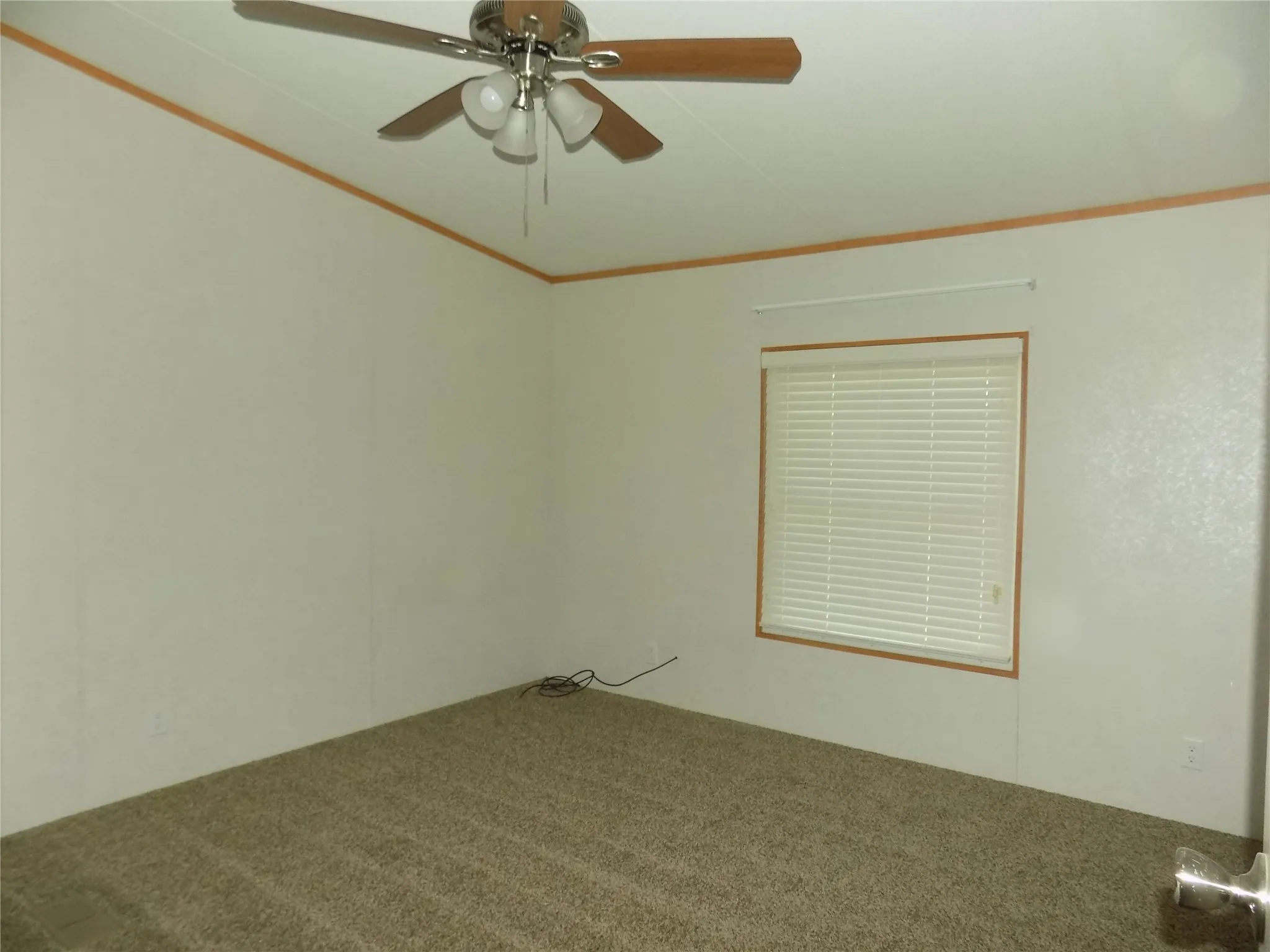A second bedroom of the secondary bedrooms with ceiling fan with lights.