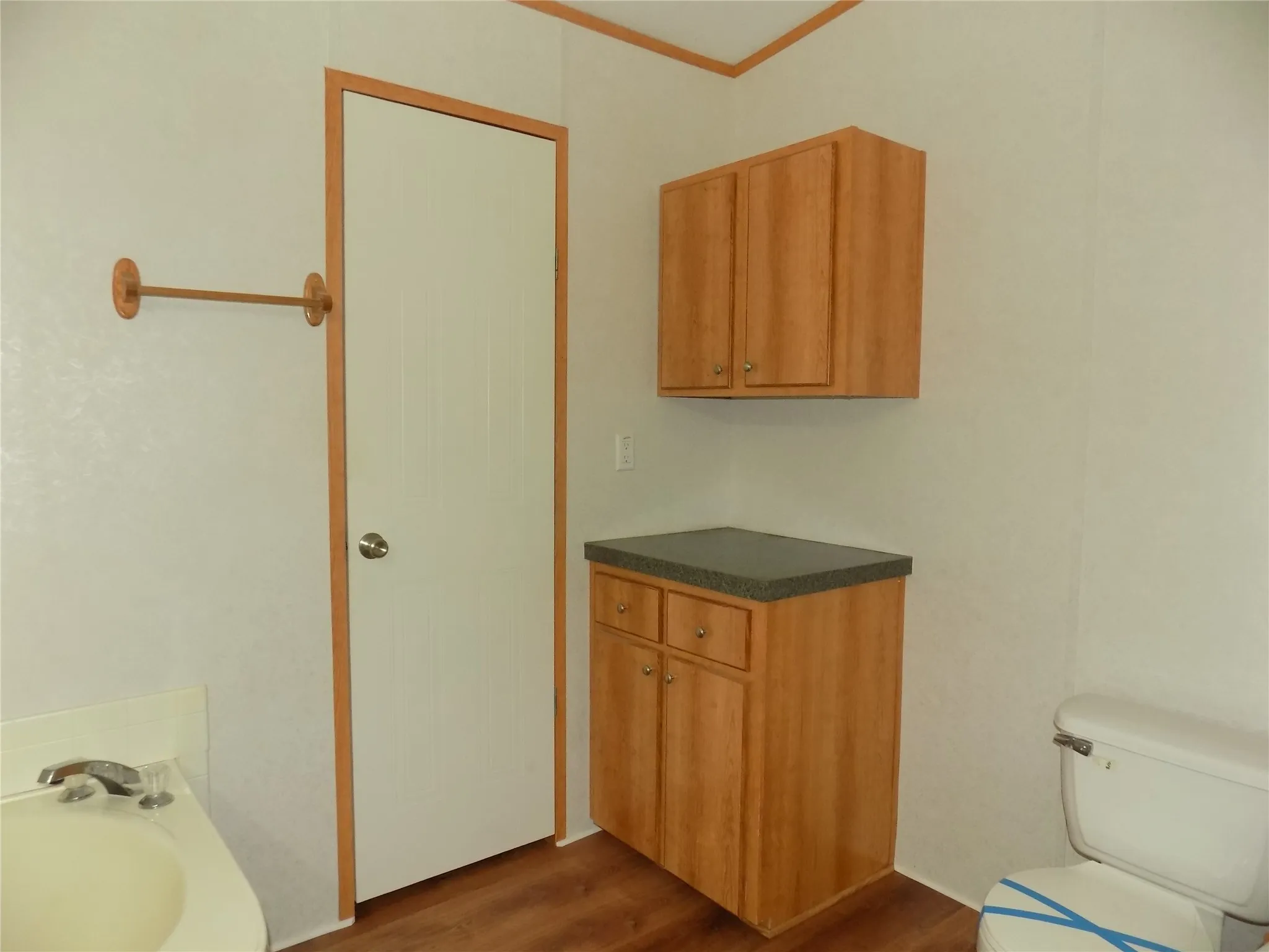 Primary bathroom with extra cabinets and counter space.  Door to walk-in closet is shown.
