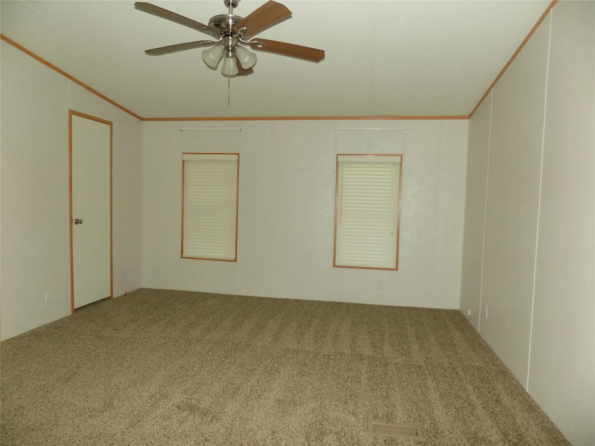 Open primary bedroom with ceiling fan with lights, and en-suite bathroom conveniently attached.