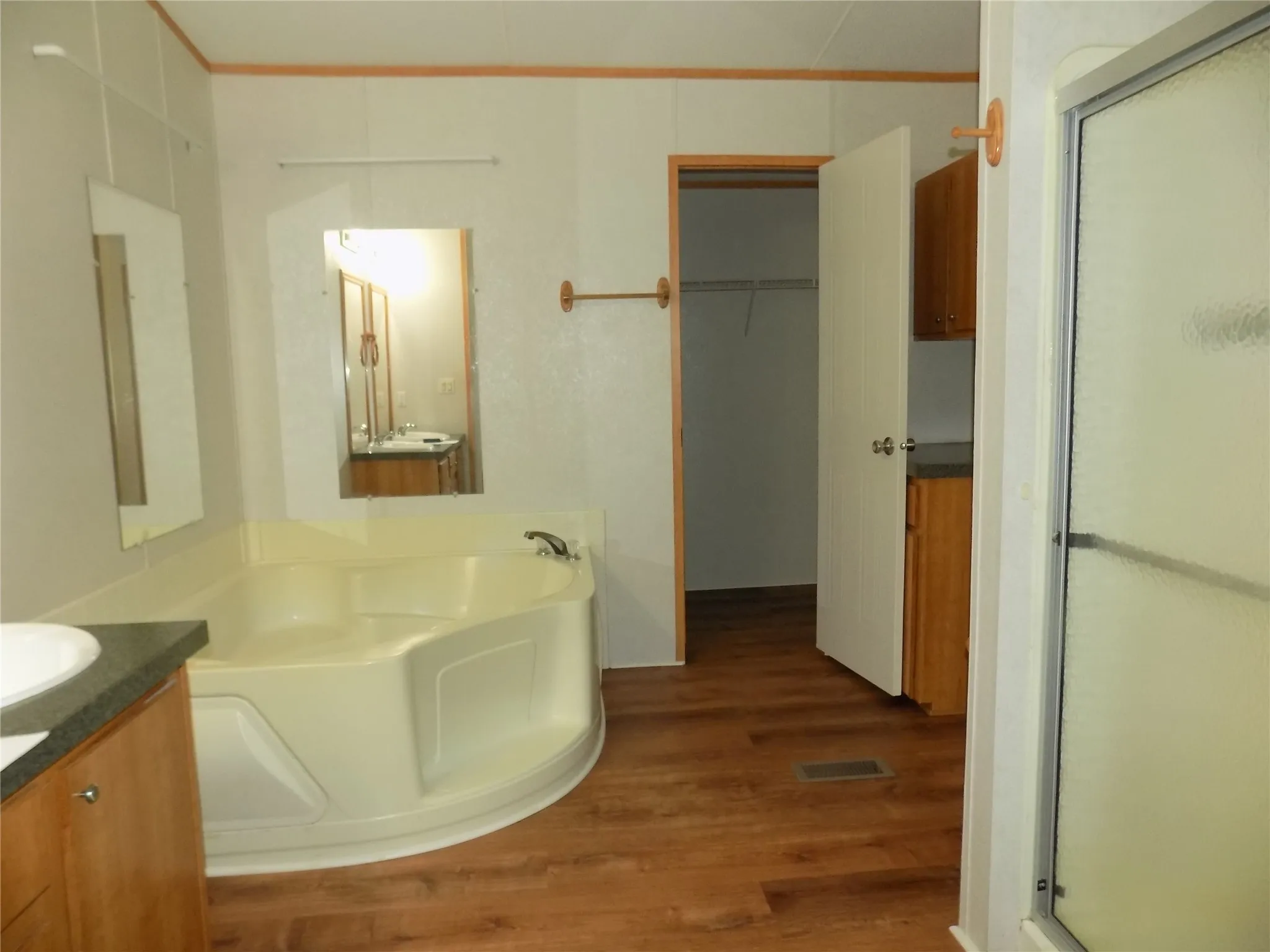 En-suite bathroom from primary bedroom, which provides dual sinks, garden tub and separate shower with walk-in closet.