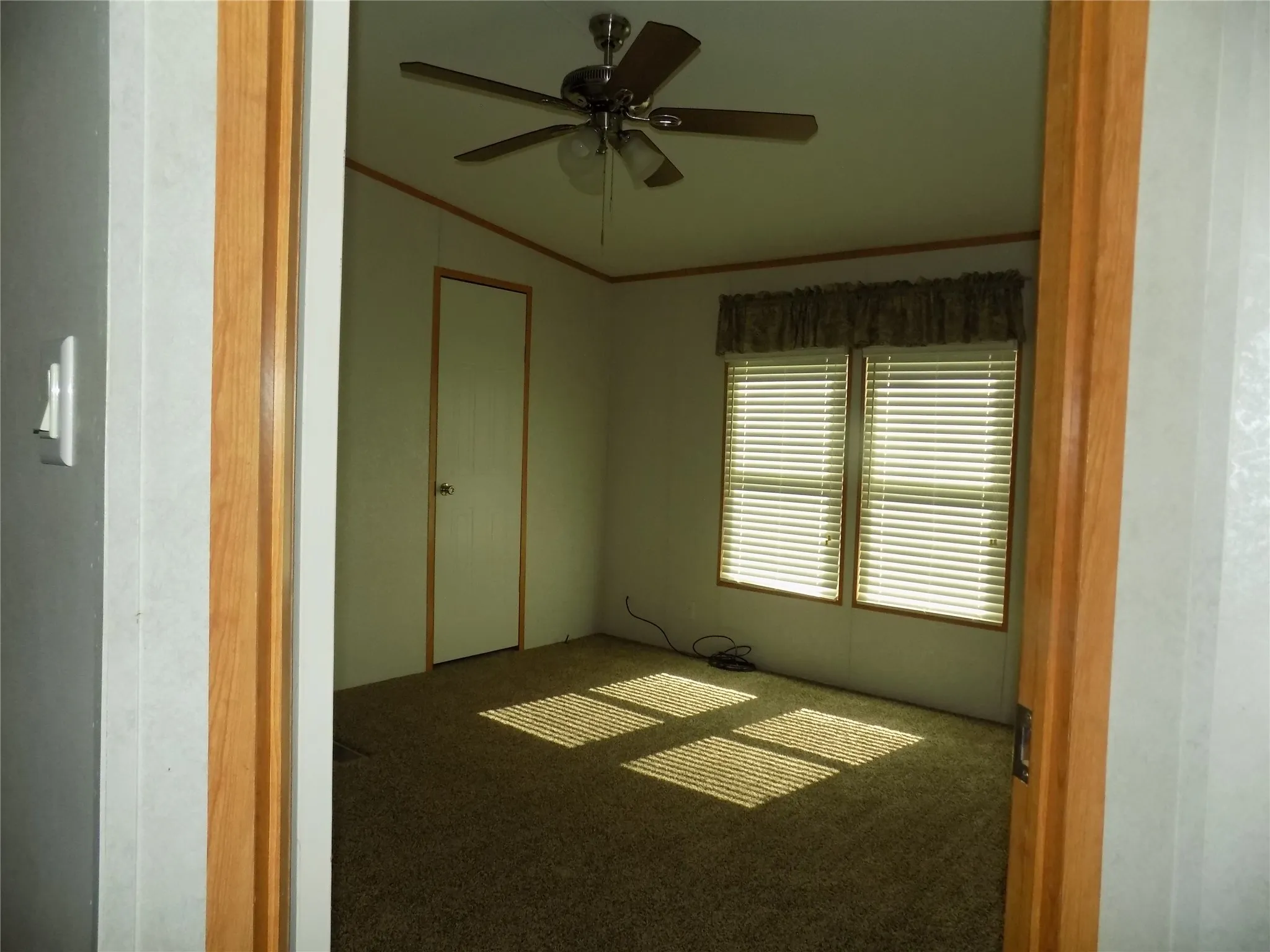 A third bedroom of the secondary bedrooms with ceiling fan with lights.
