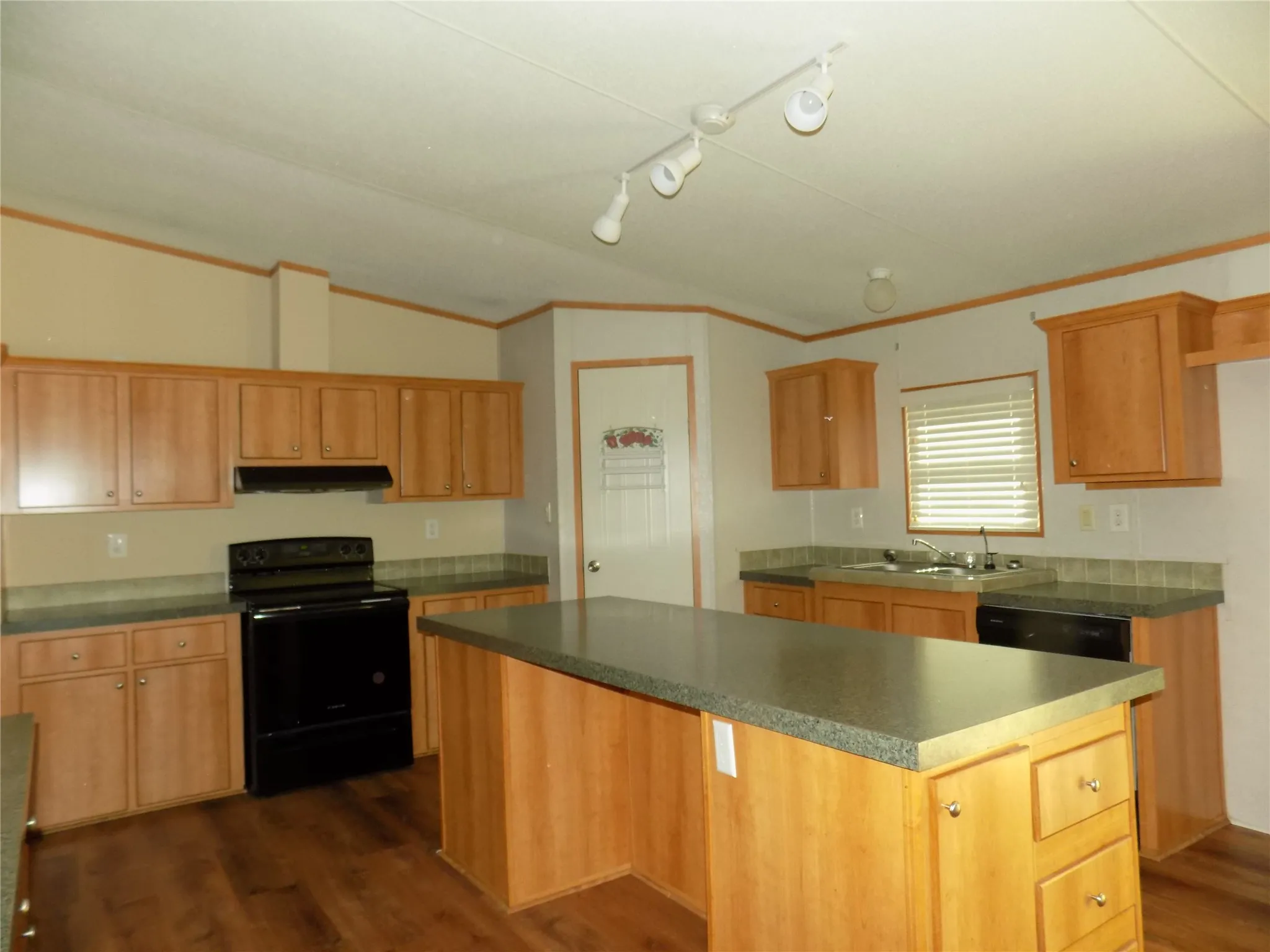 Awesome kitchen view, loaded with cabinets and counter space, large center island, walk-in pantry, and window above double stainless steel sink. Spacious wonderful kitchen.