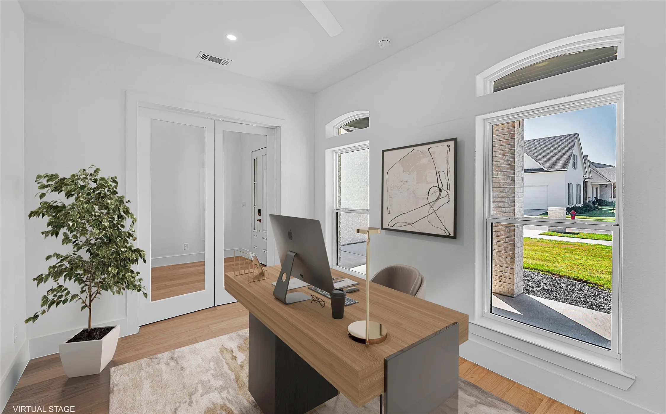Recessed lighting, wood-finish flooring, and white trim throughout